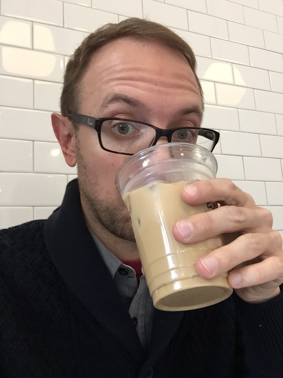 Kevin drinking a latte