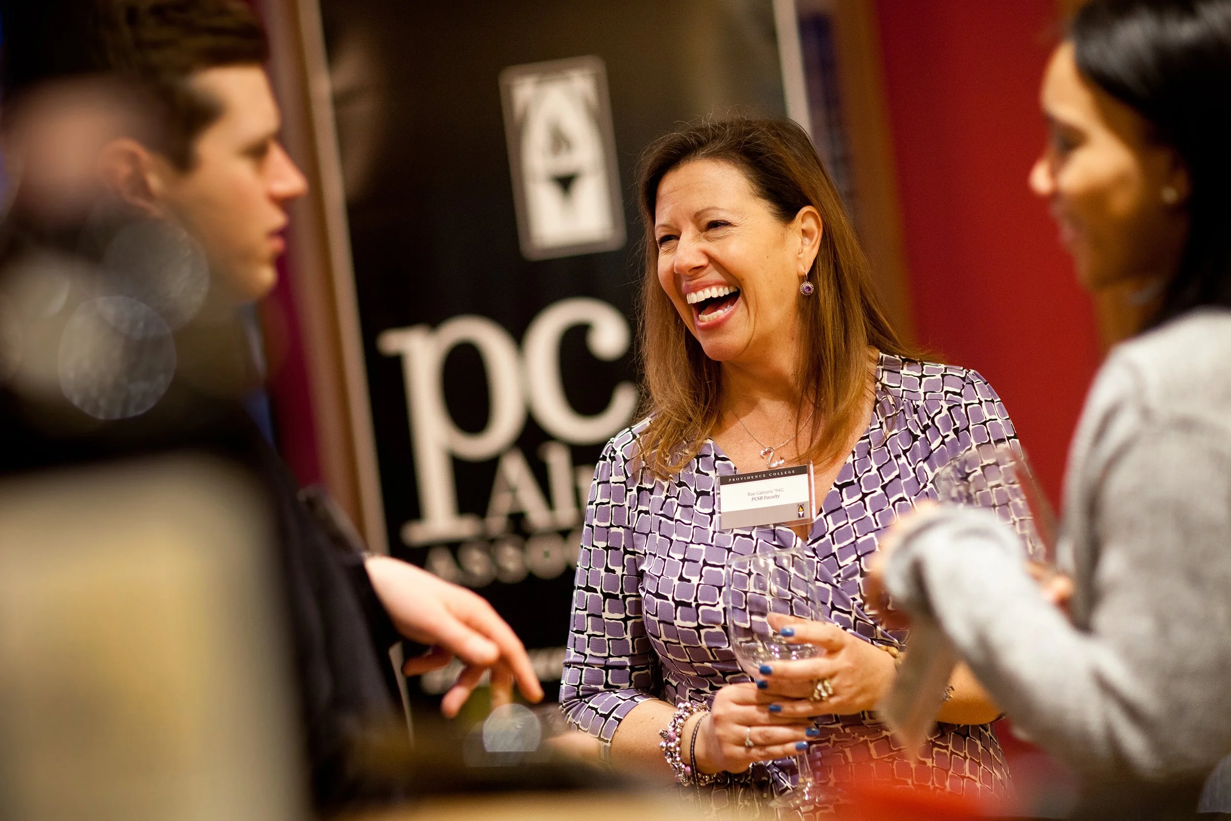 Woman laughing at Providence College networking event