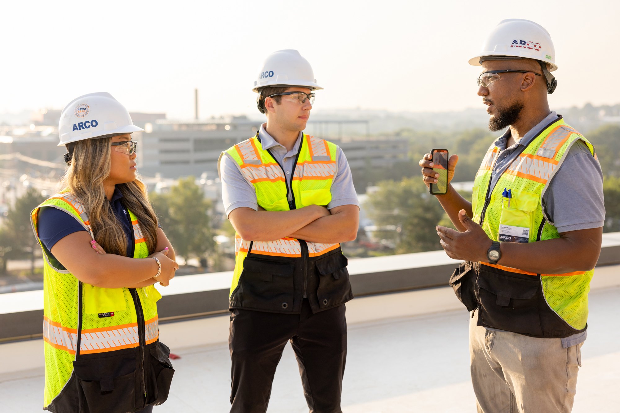 Group of construction workers on roof talking
