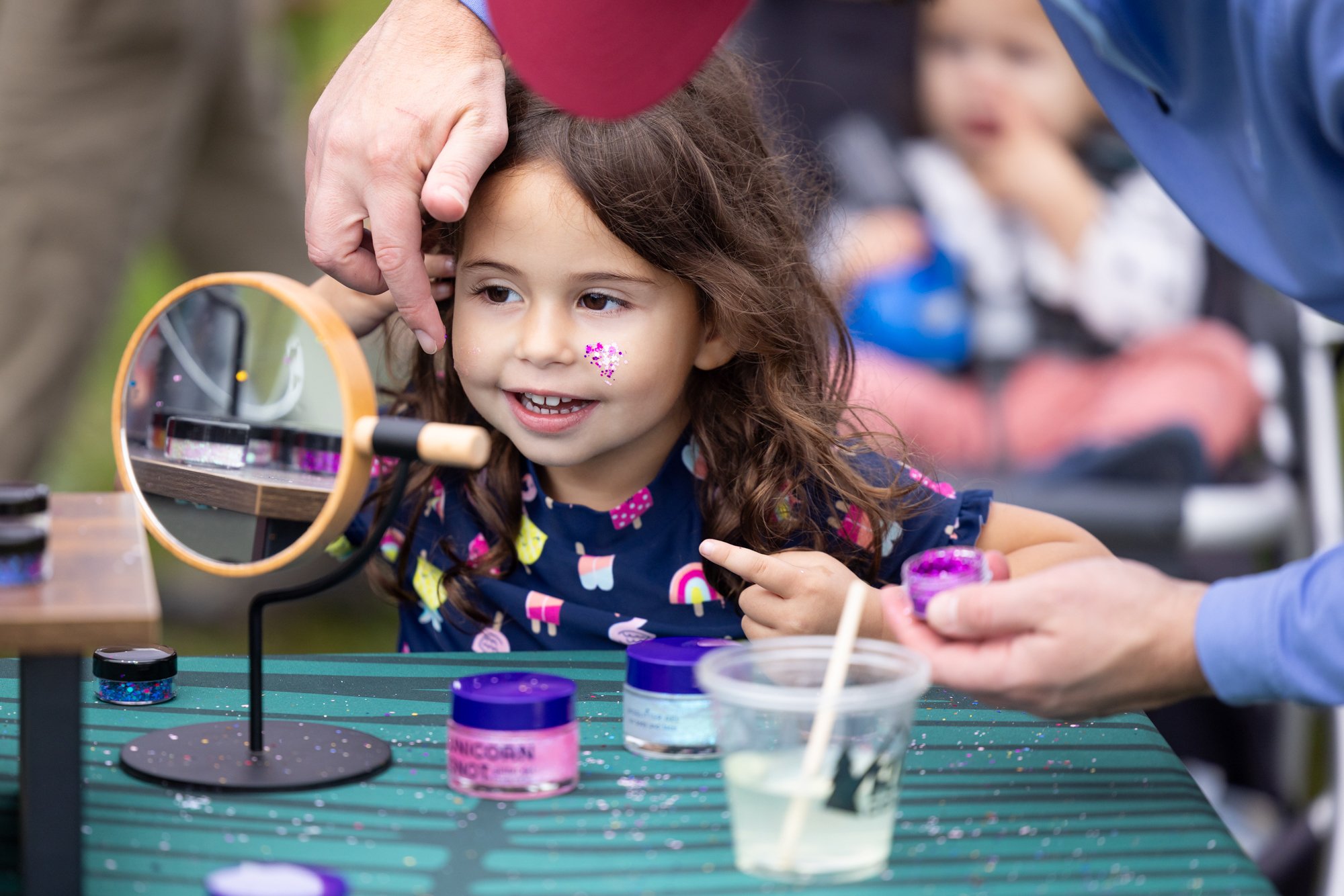 Child having glitter put on