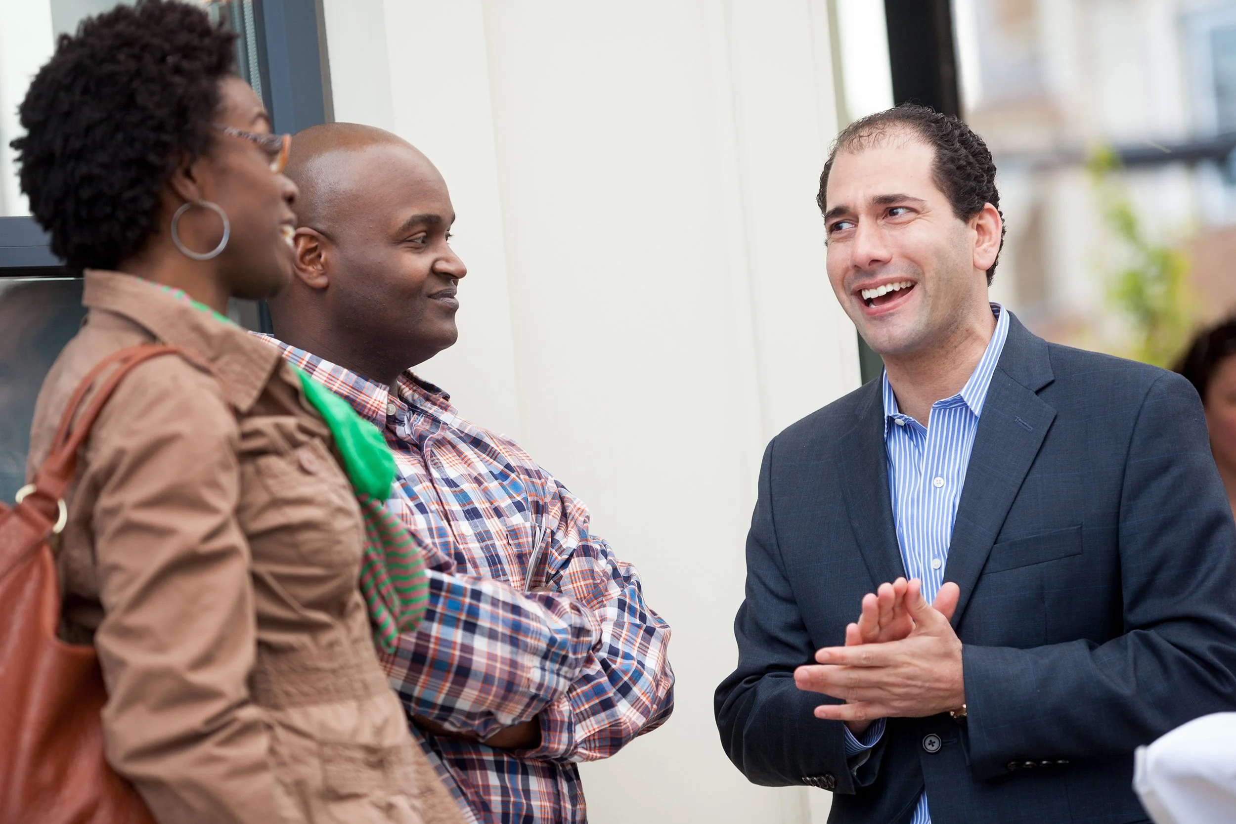 Three people speaking during dedication event