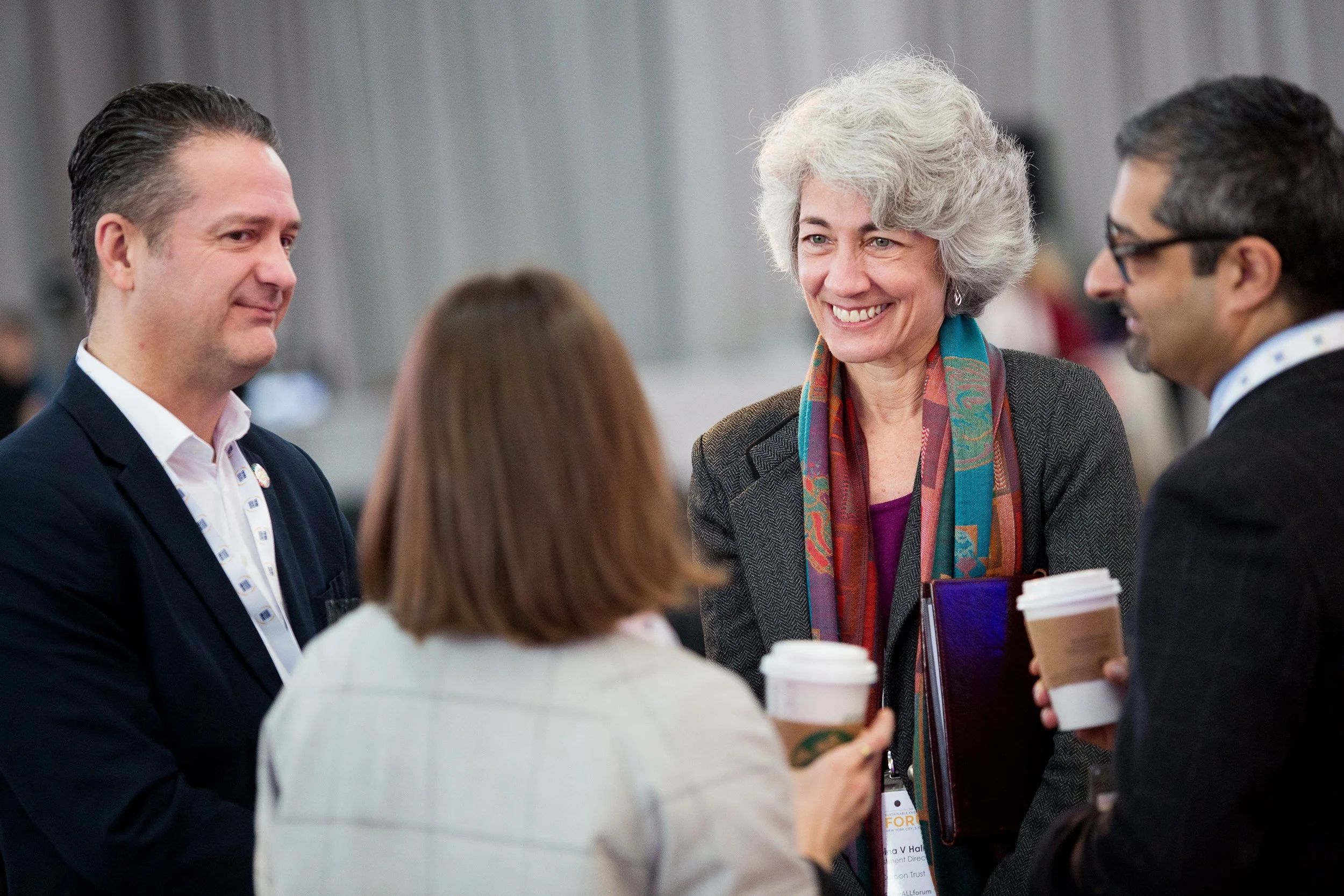 Group of people standing around talking at event