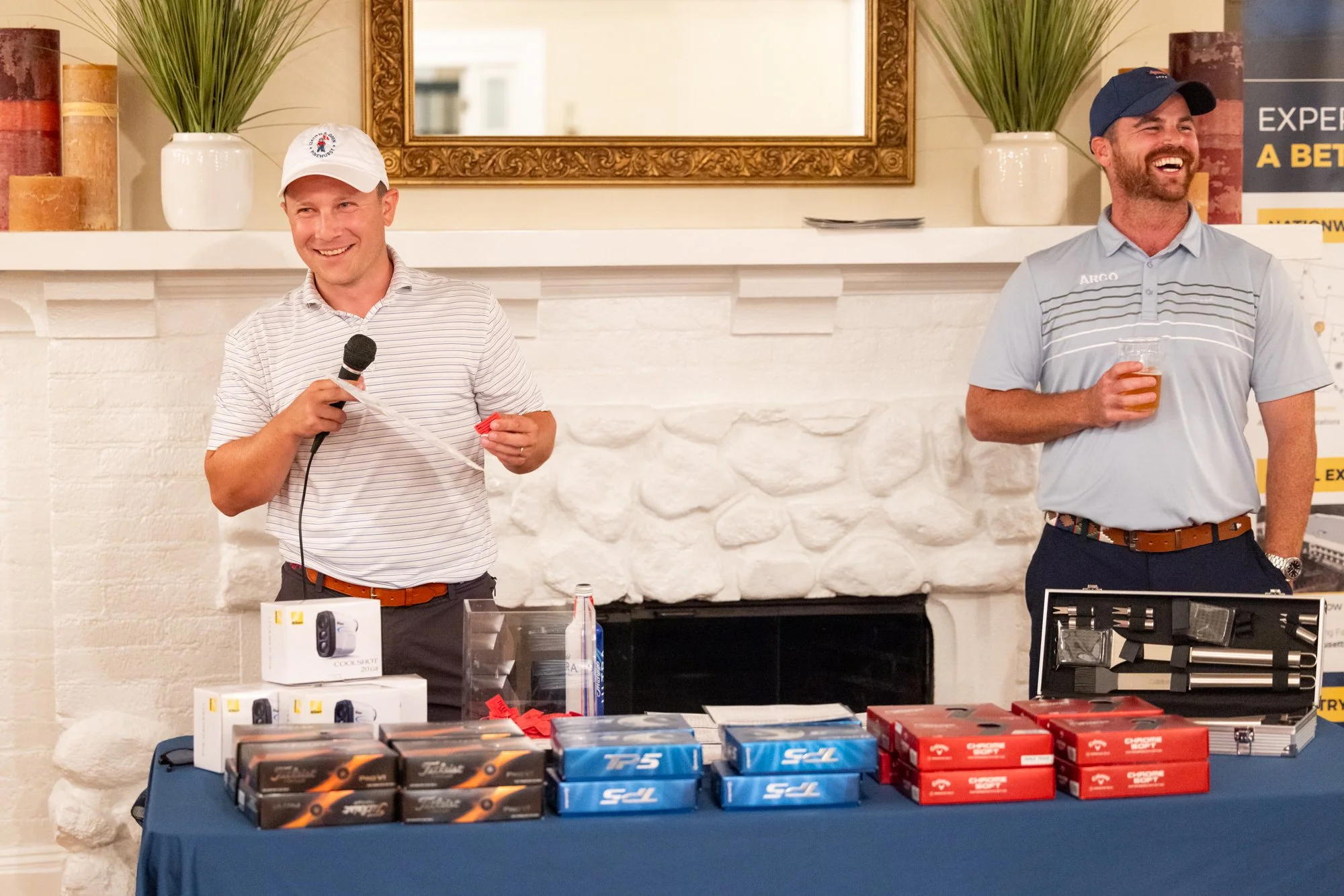 Two people laughing during corporate golf event raffle