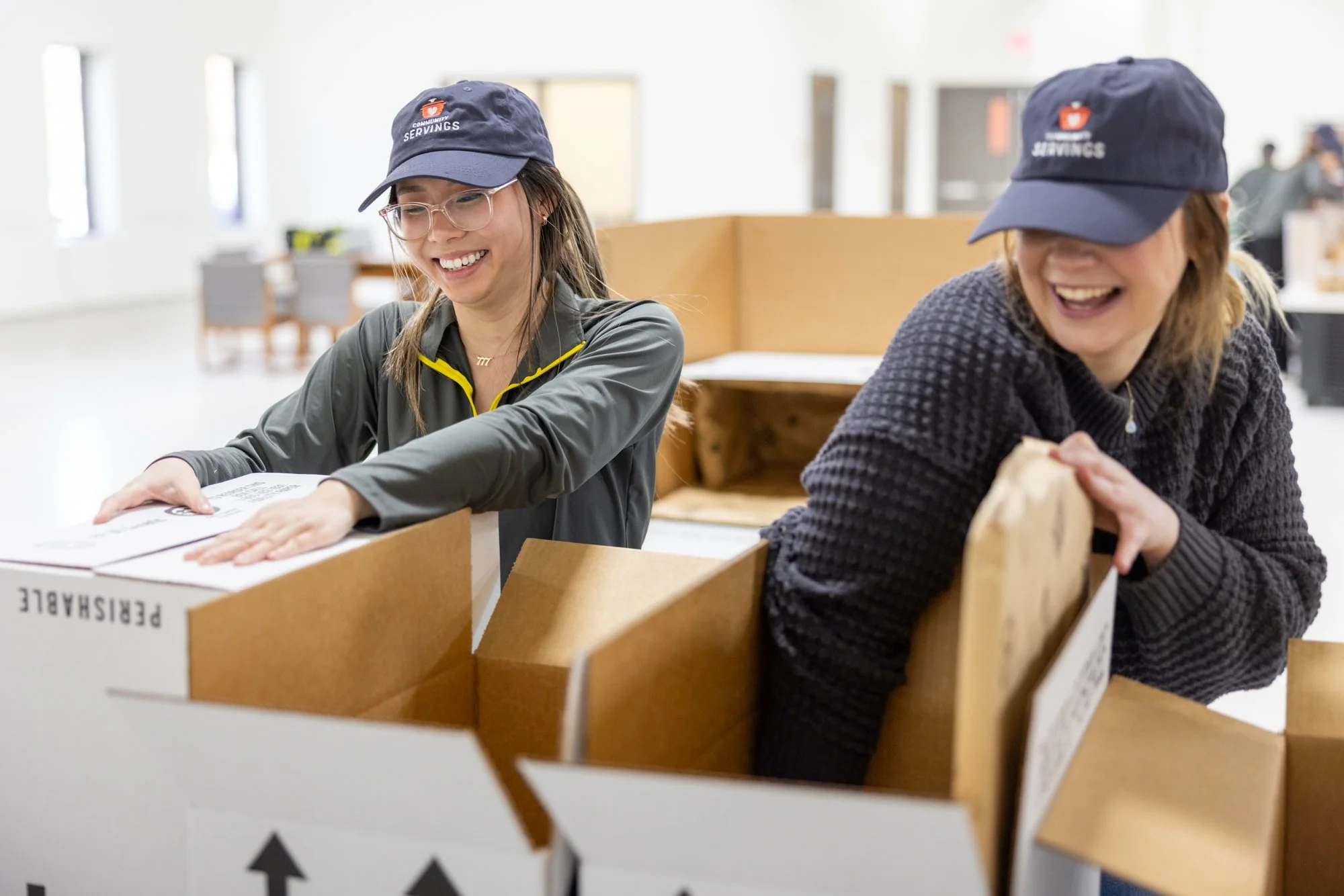 Two people packing boxes