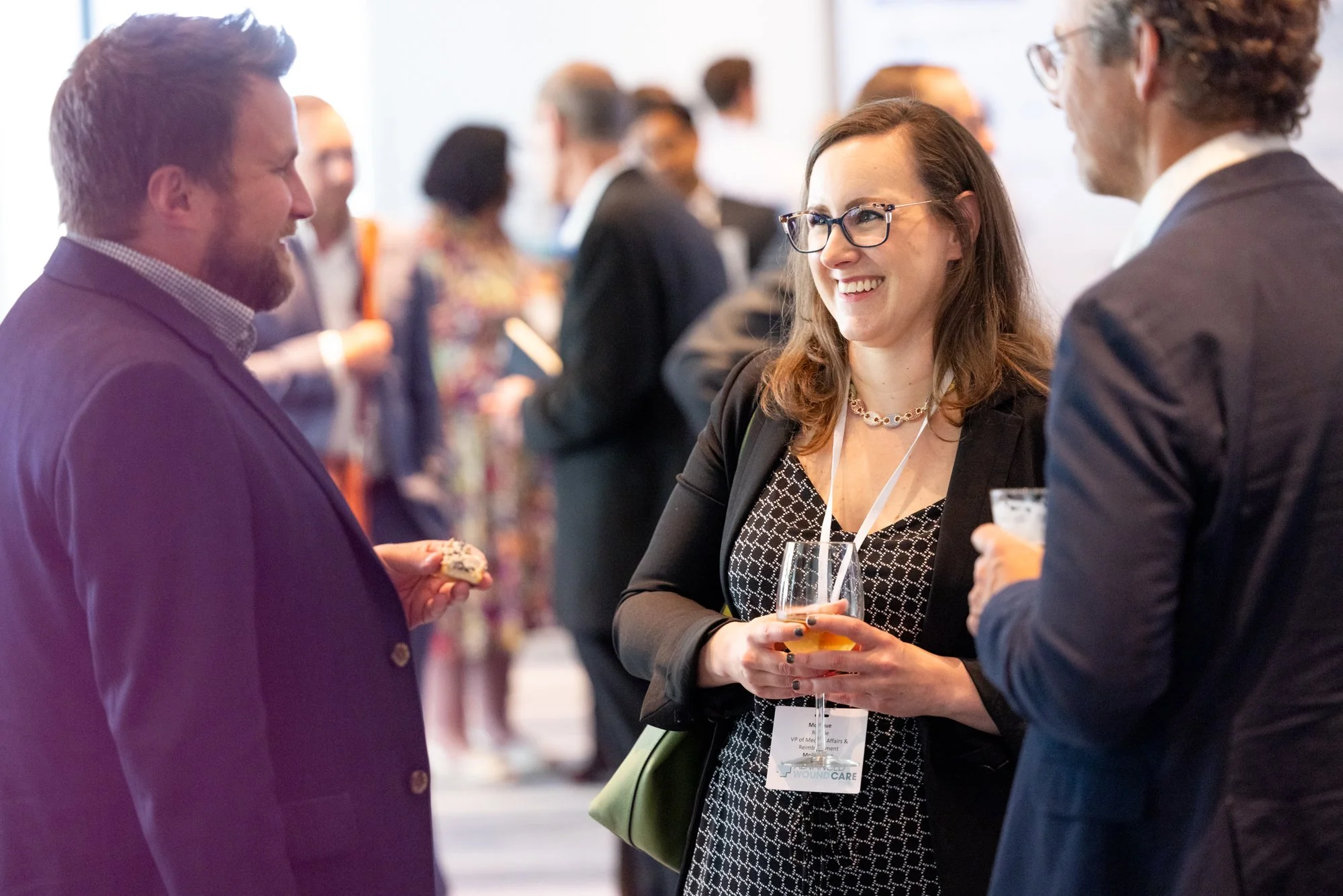 Three people speaking during cocktail hour