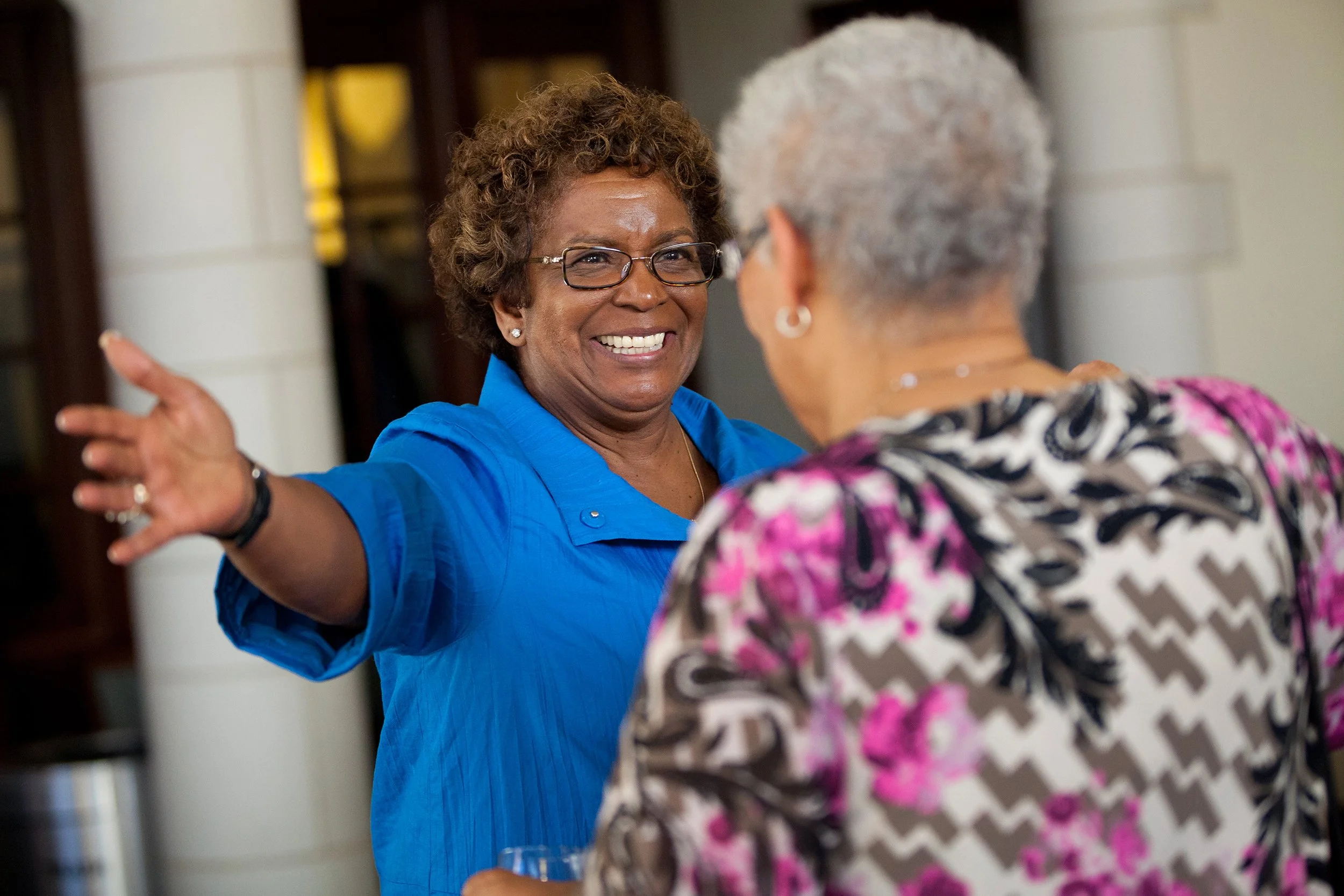 Woman reaching out to hug a friend