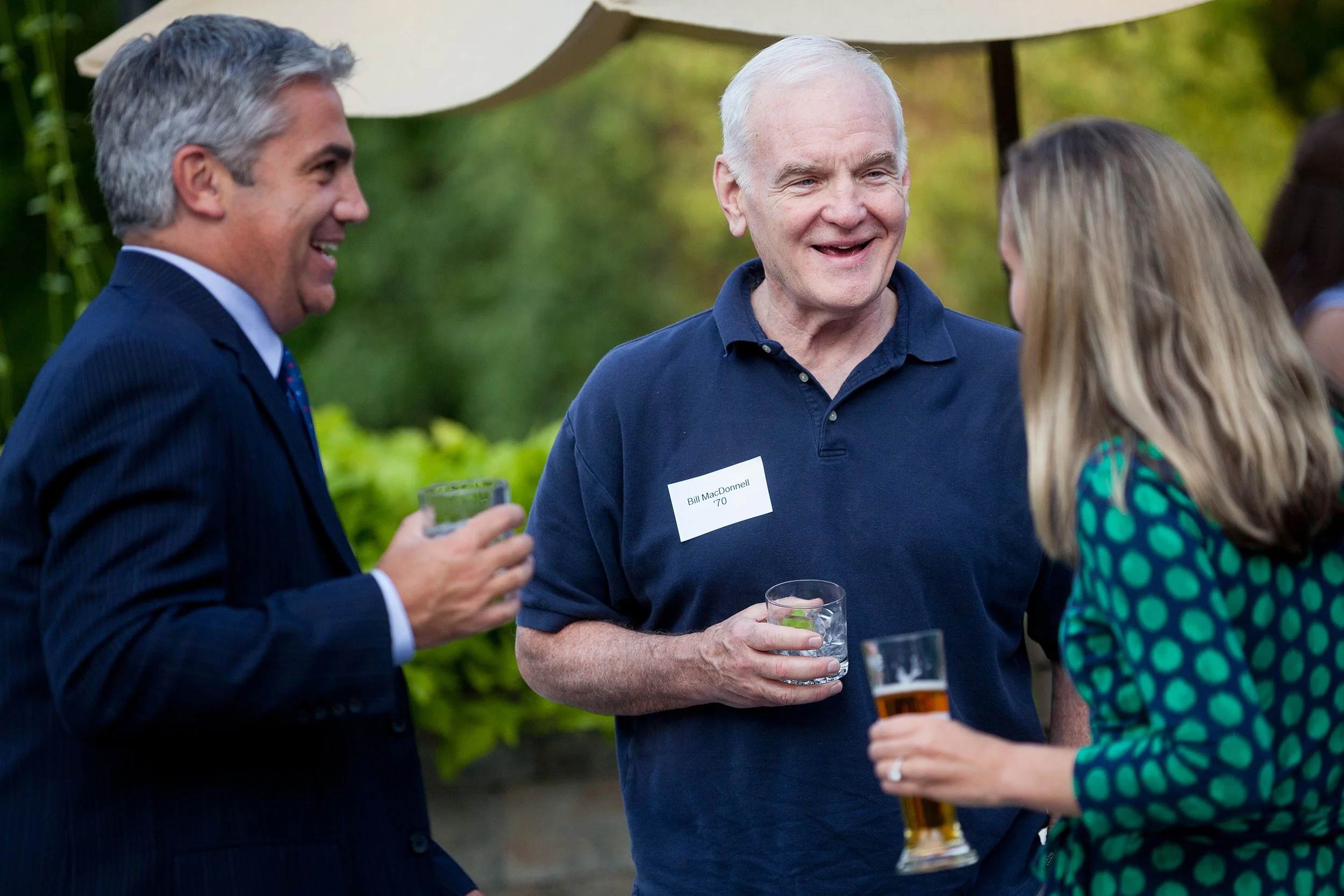 Three people speaking at outdoor networking event