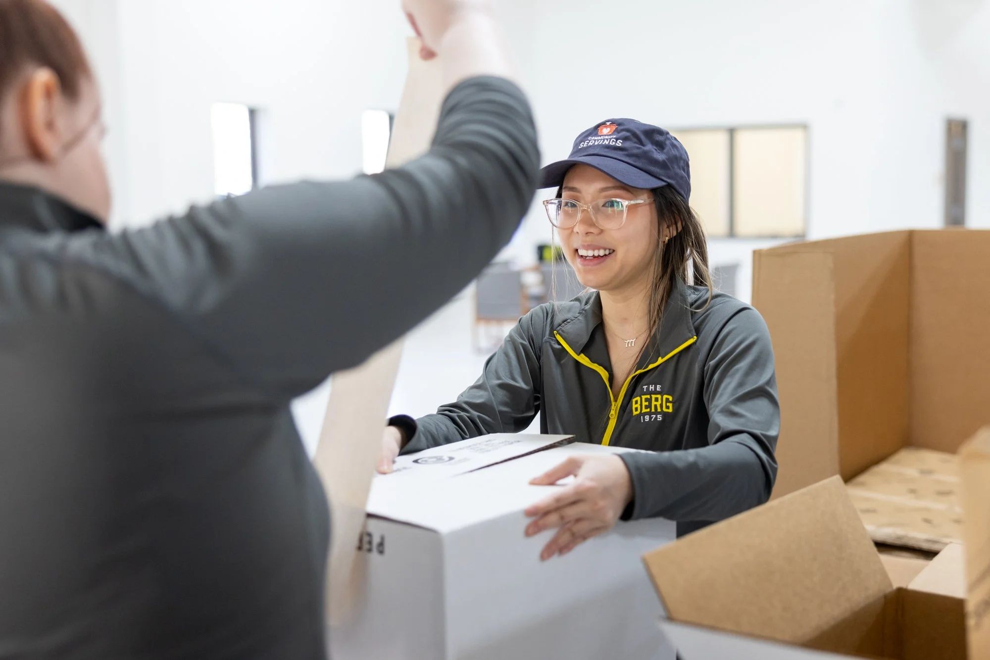 Woman laughing while packing boxes