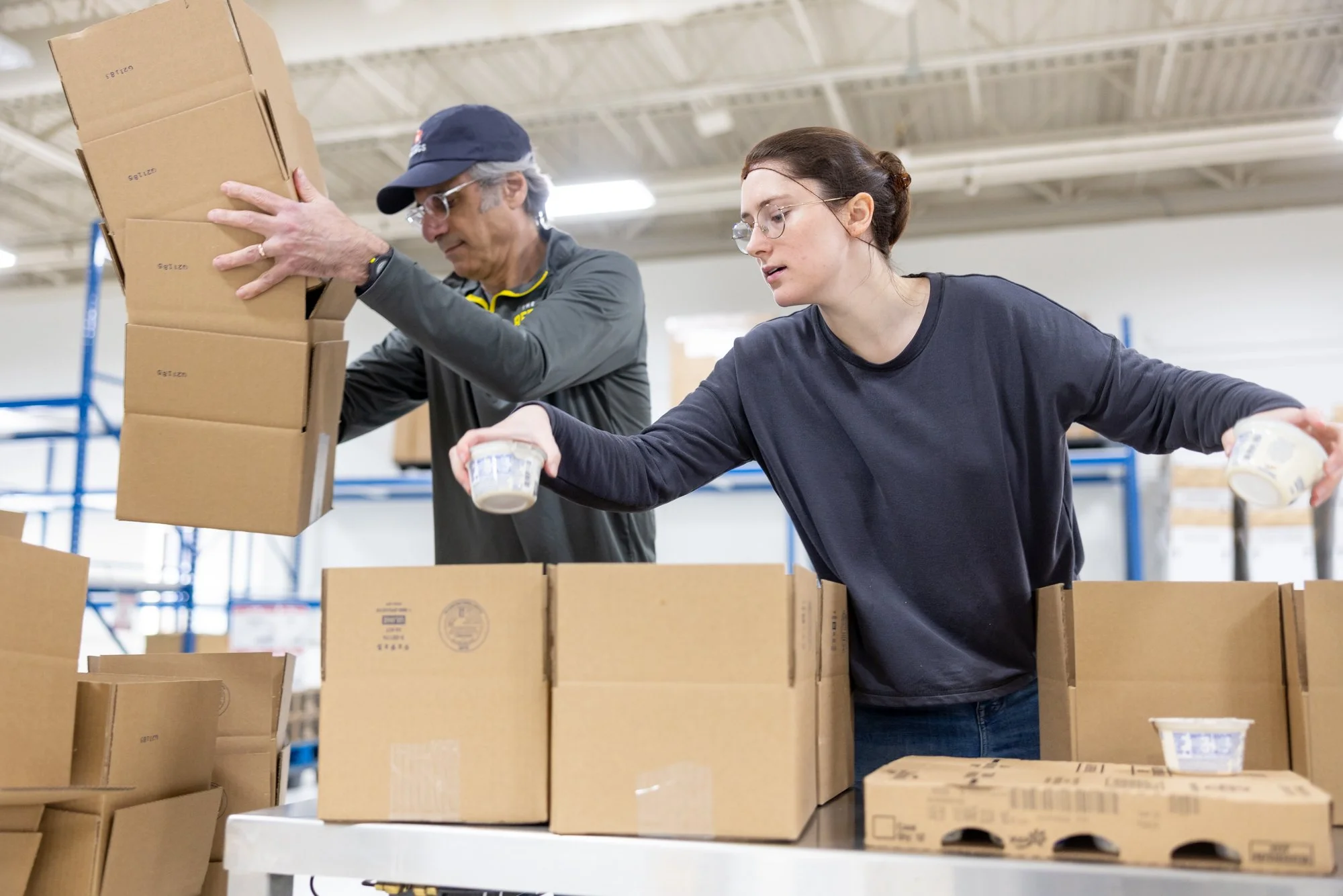 Two people packing boxes

