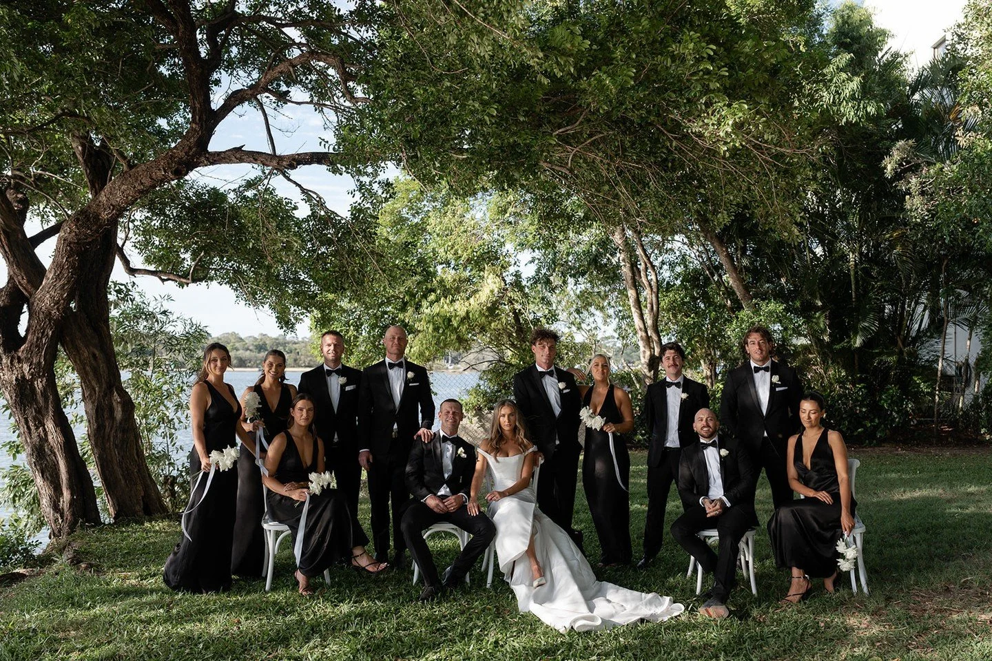 A study in elegance and energy - Emma and Ben&rsquo;s bridal party bringing equal parts polish and party🖤⁠
⁠
Styling &amp; Stationery: @lovebirdweddings⁠
Florals: @mondofloraldesigns⁠
Venue: Sound Park &amp; @rickys_noosa @rickysweddings⁠
Photograph