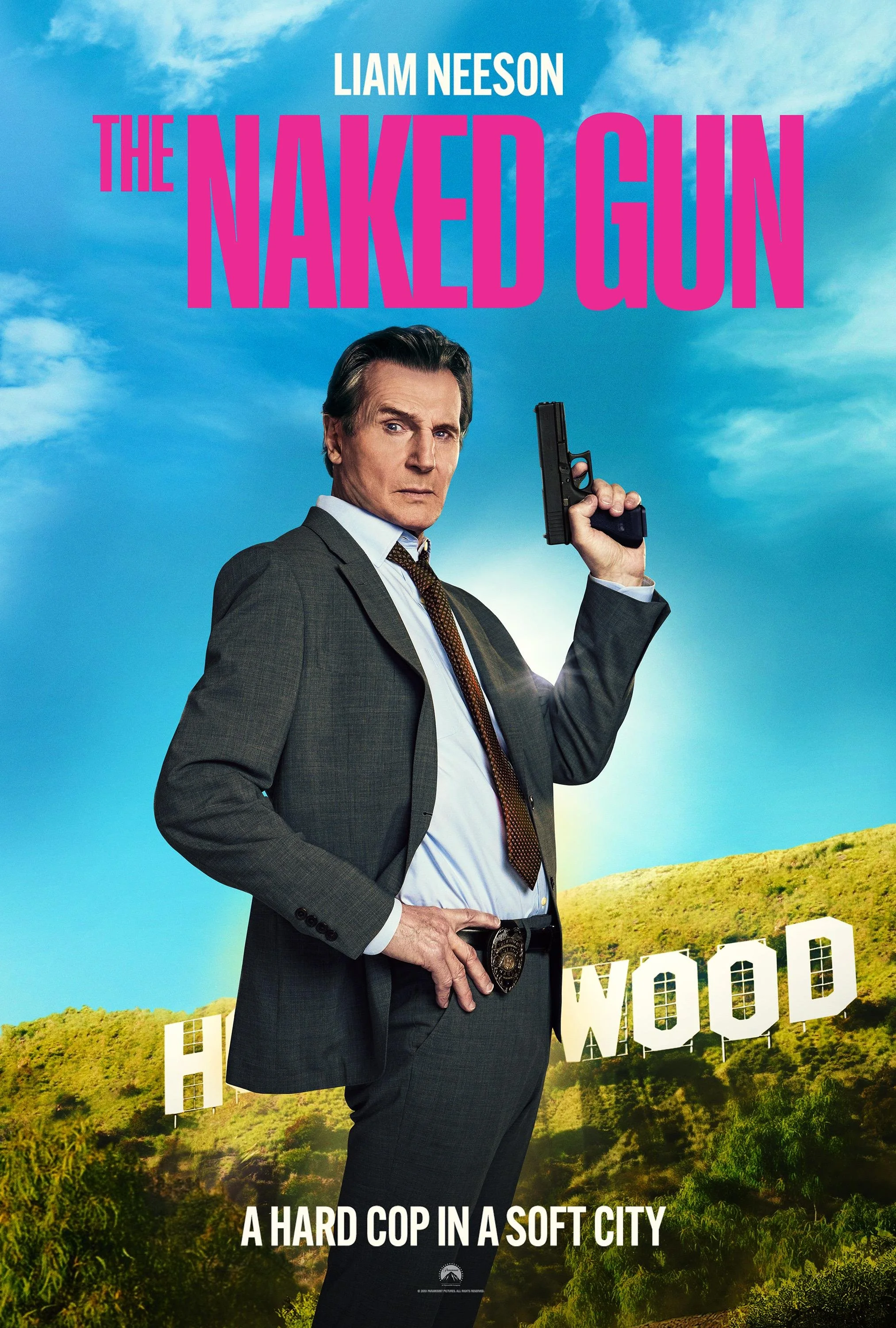 Movie poster for 'The Naked Gun' featuring a man in a police suit holding a gun, standing in front of the Hollywood sign with a blue sky background.