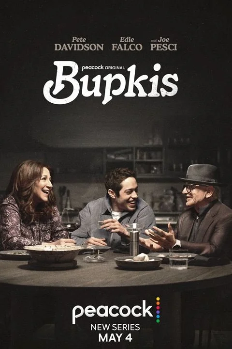 Movie poster for 'Bupkis' featuring three people sitting at a dinner table, smiling and talking, with the title and actors' names above and the 'Peacock' streaming service logo at the bottom, and the premiere date May 4.