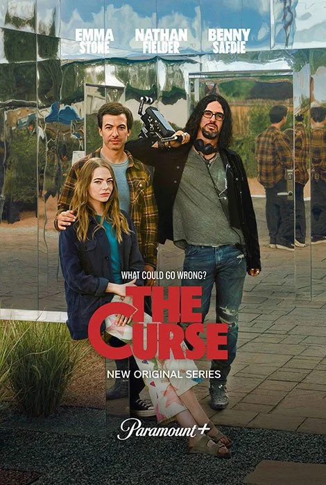 Poster for the TV series 'The Curse' featuring three characters standing in front of a reflective building. The characters include a young girl with blonde hair, a man with short hair and a plaid shirt, and a man with long hair and glasses holding a