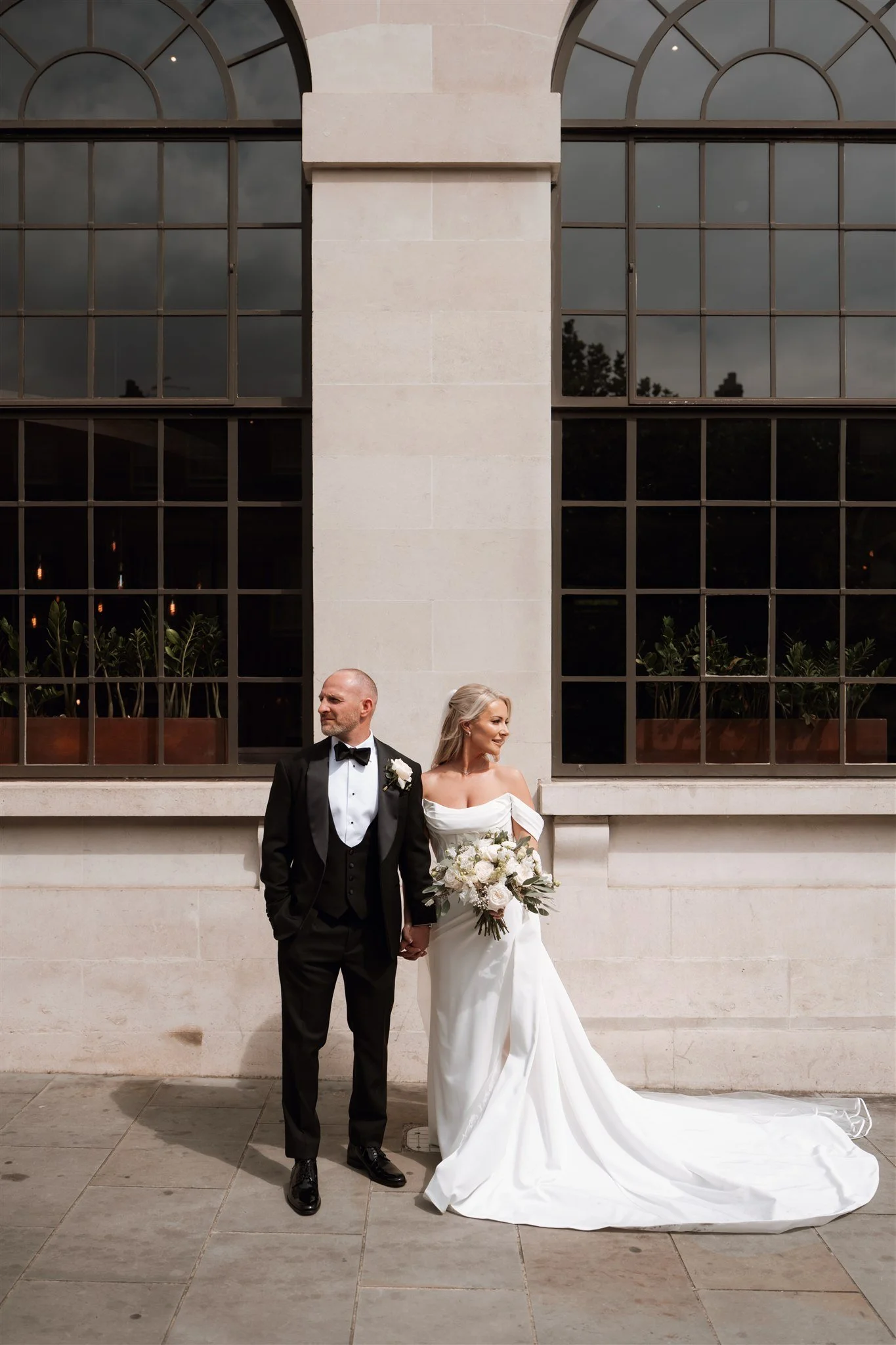 Bride and groom holding hands outside Leeds wedding venue