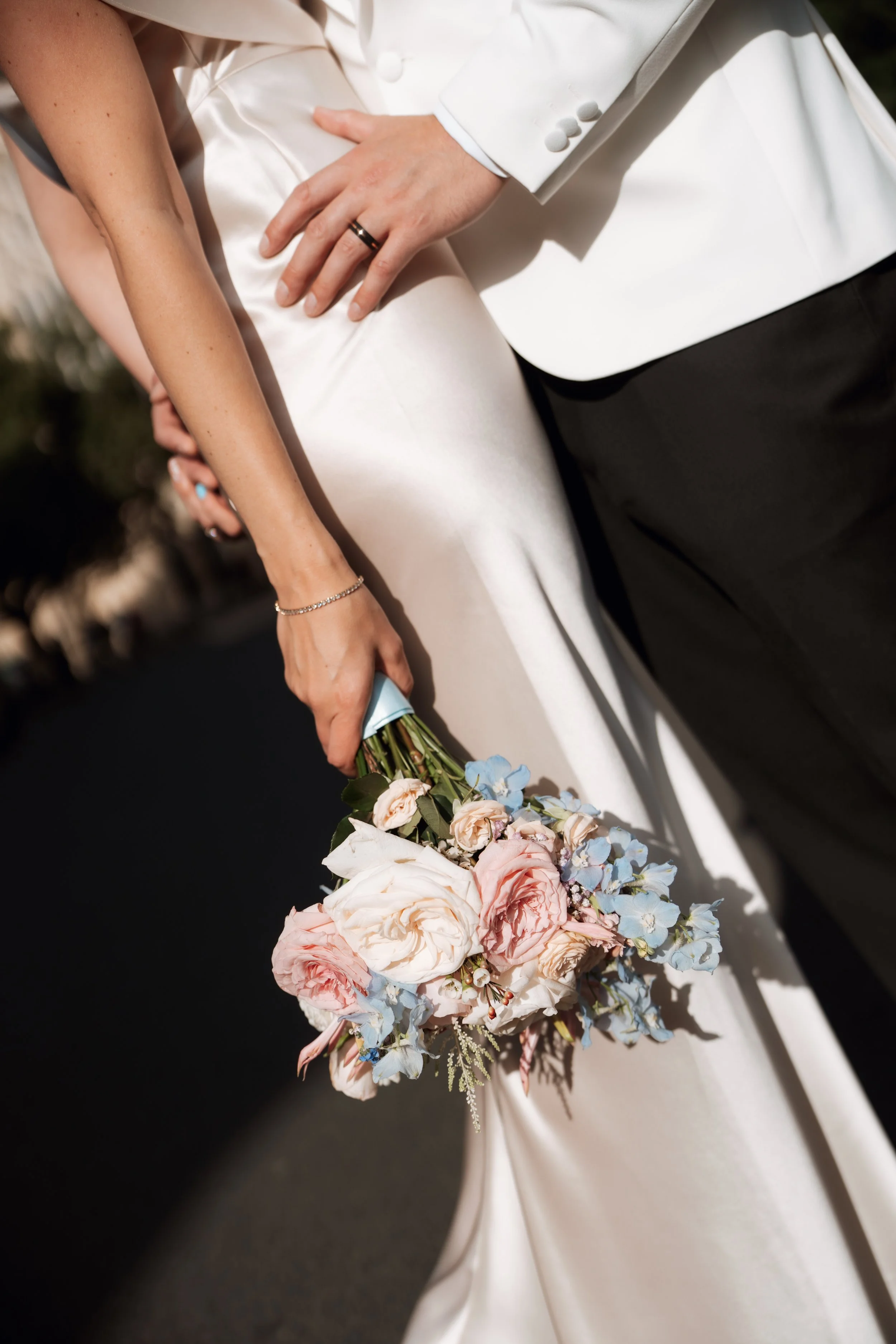 Bride holding pink, white, and blue bouquet after wedding ceremony in York 