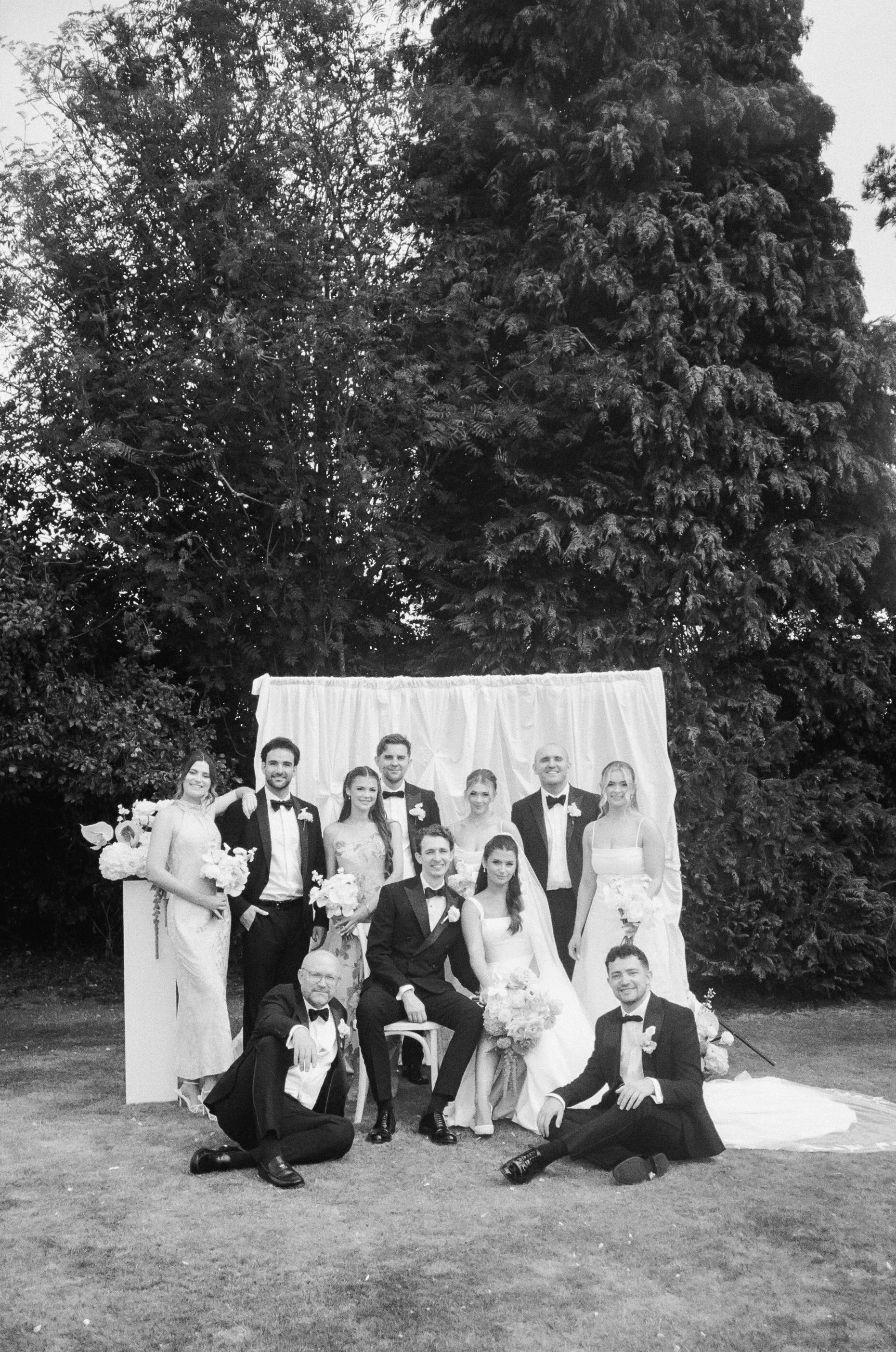 Black and white photo of a wedding group outdoors in Manchester taken on 35mm film 