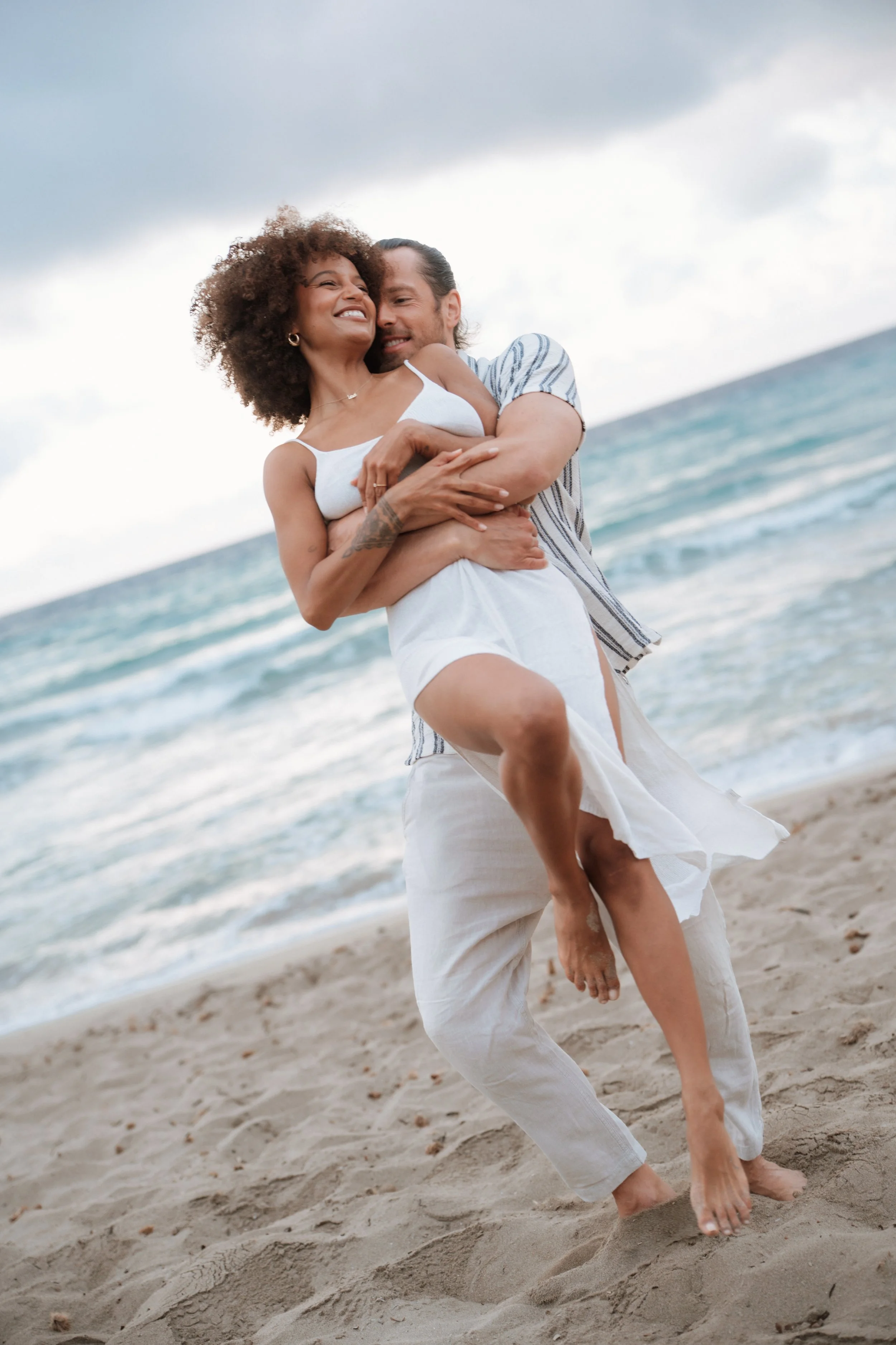 A happy couple having fun on an Ibiza beach