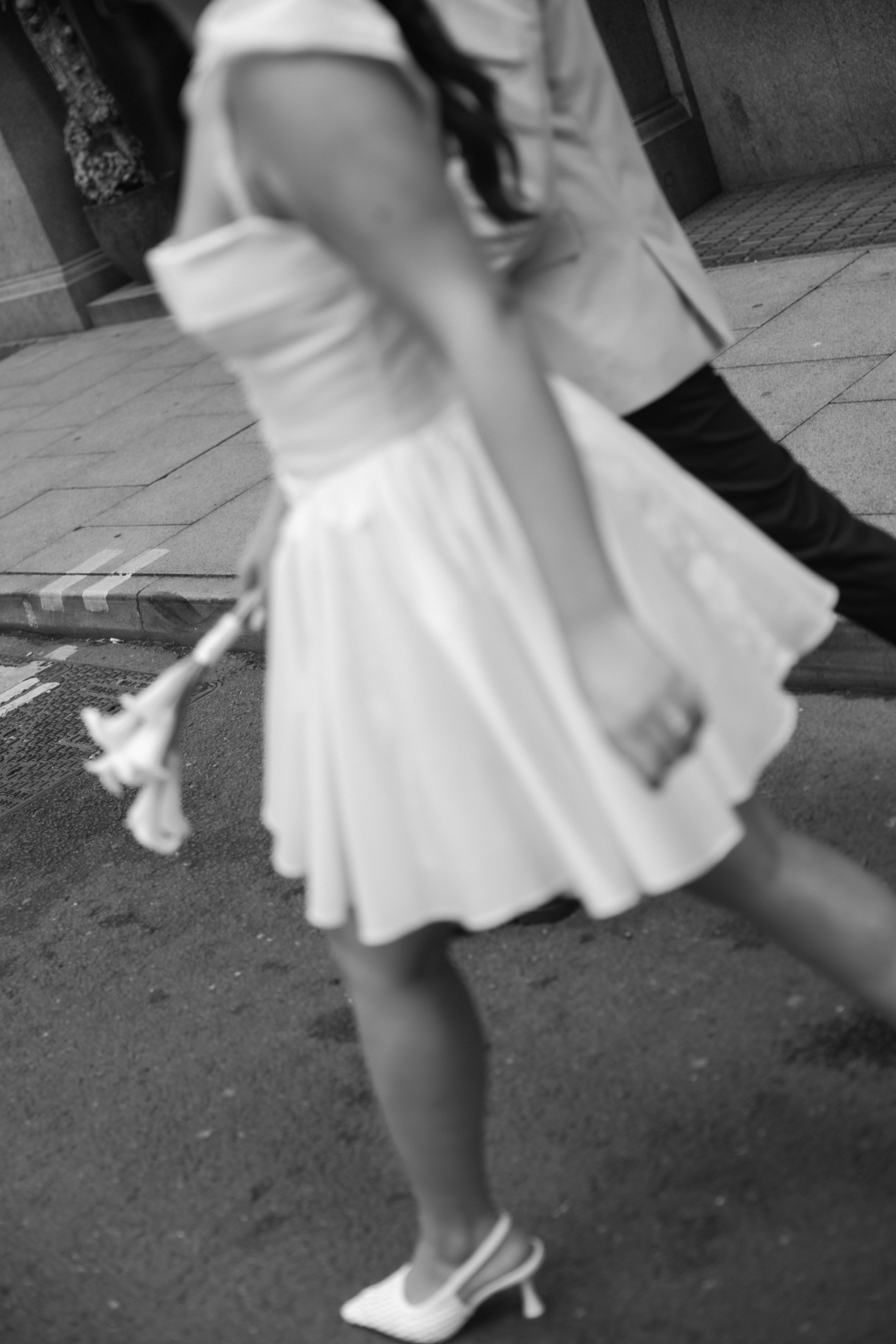 editorial photo of bride and groom walking in Manchester street 