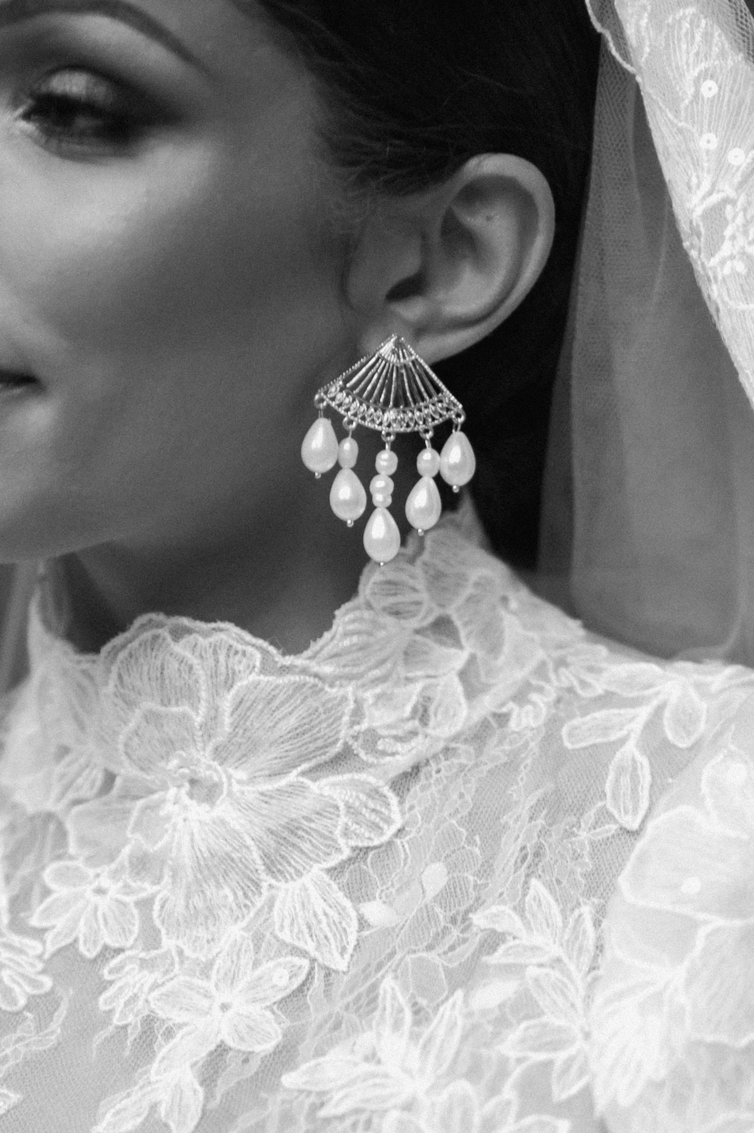 Close-up of a woman wearing an intricate lace dress at Harlaxton Manor