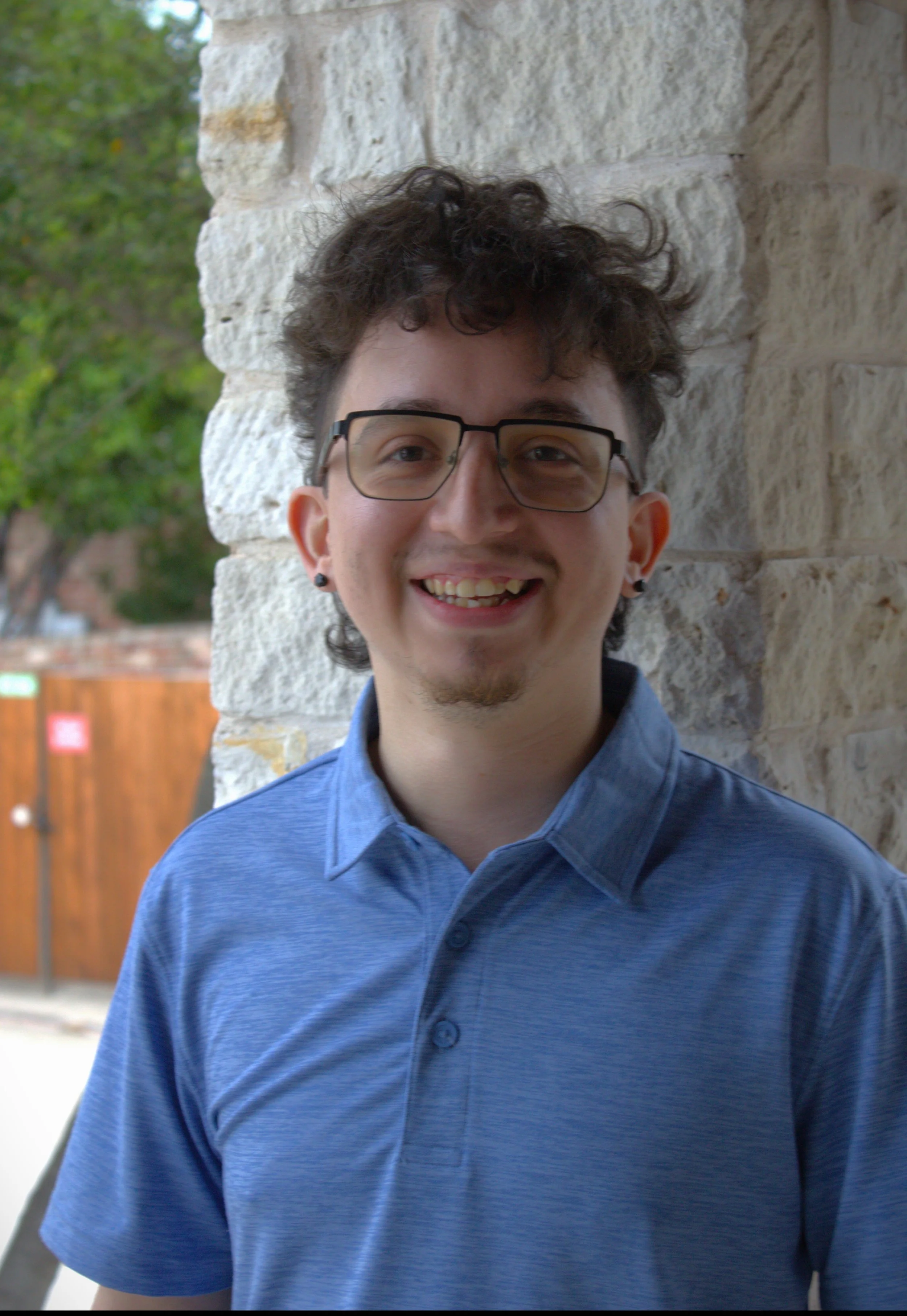 Nate Gandara, a private chess instructor in the DFW area, sitting at a chessboard and smiling.