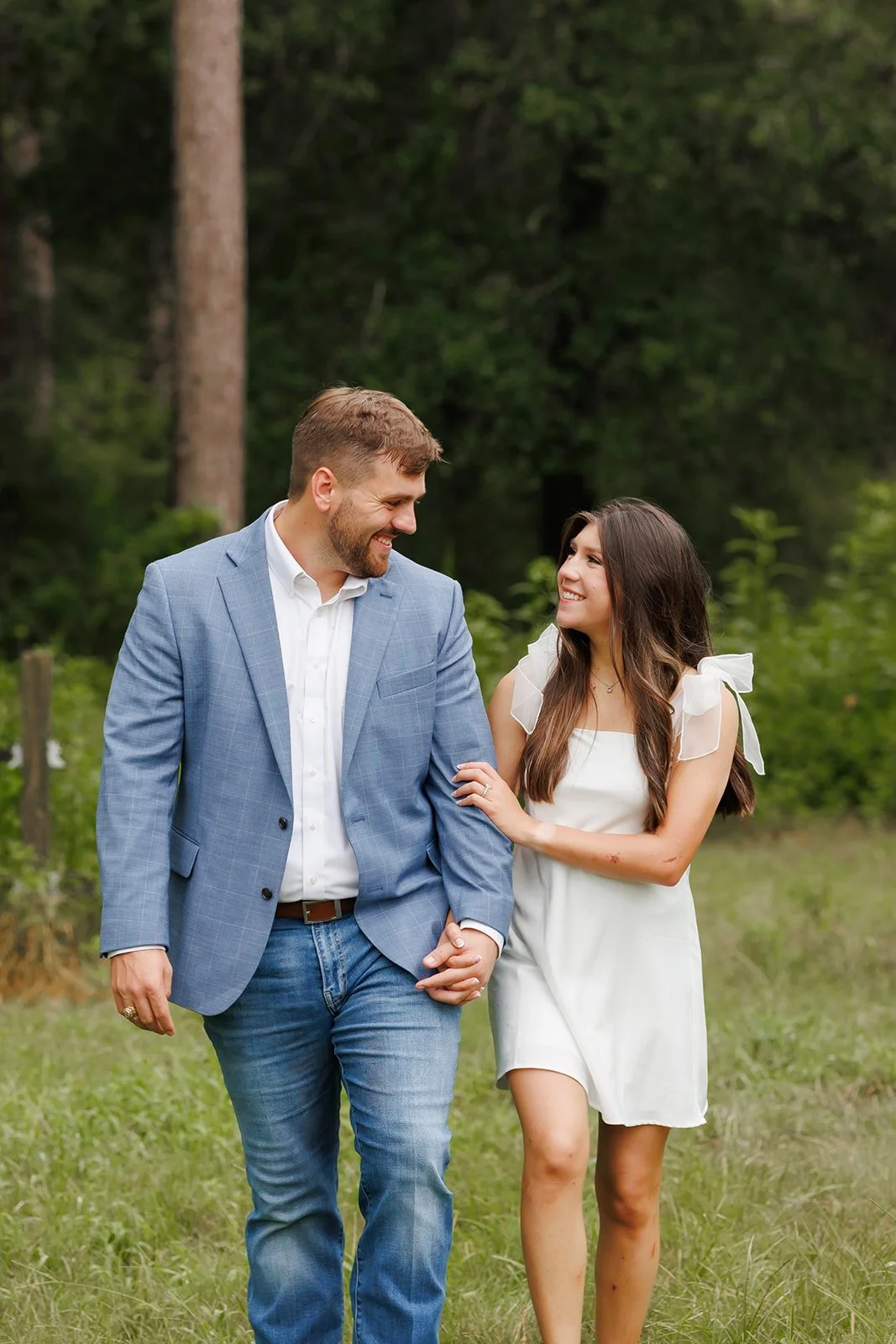Natural light engagement session in The Woodlands at WG Jones as a couple walks hand-in-hand through a forest trail — Wild Ivy Creative.