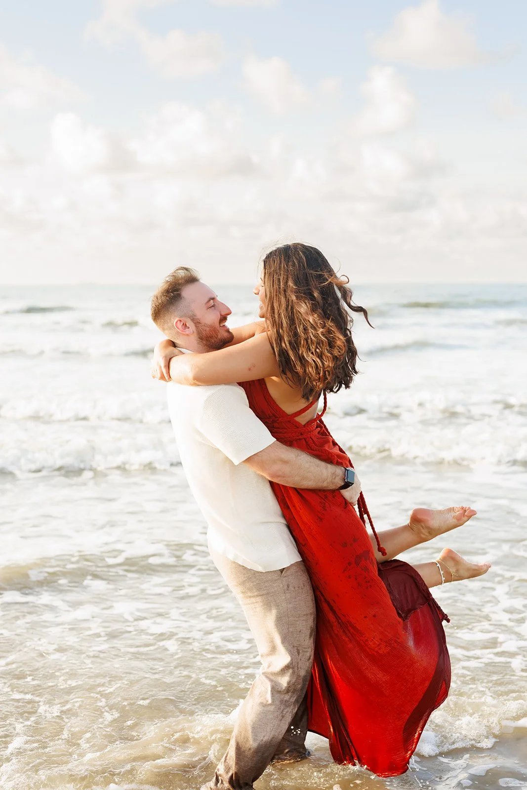 Wild Ivy Creative Photo-238.jpgCouple splashing in the water during playful and relaxed engagement photos on Galveston beach.