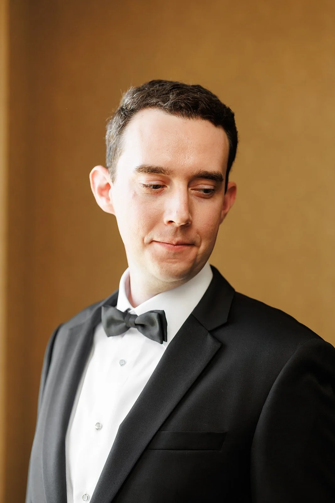 Formal groom portraits in luxury Houston hotel venue after getting ready on his wedding day while being captured by Wild Ivy Creative Photography