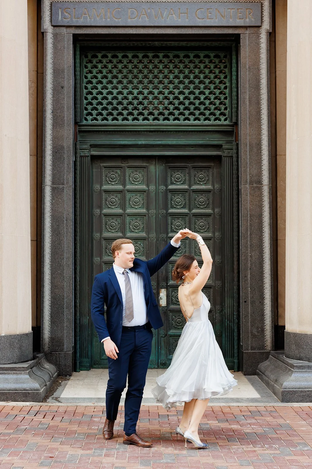 Chic and formal Houston engagement photo in front of the ornate doors of the Islamic Dawah Center — captured by Wild Ivy Creative.