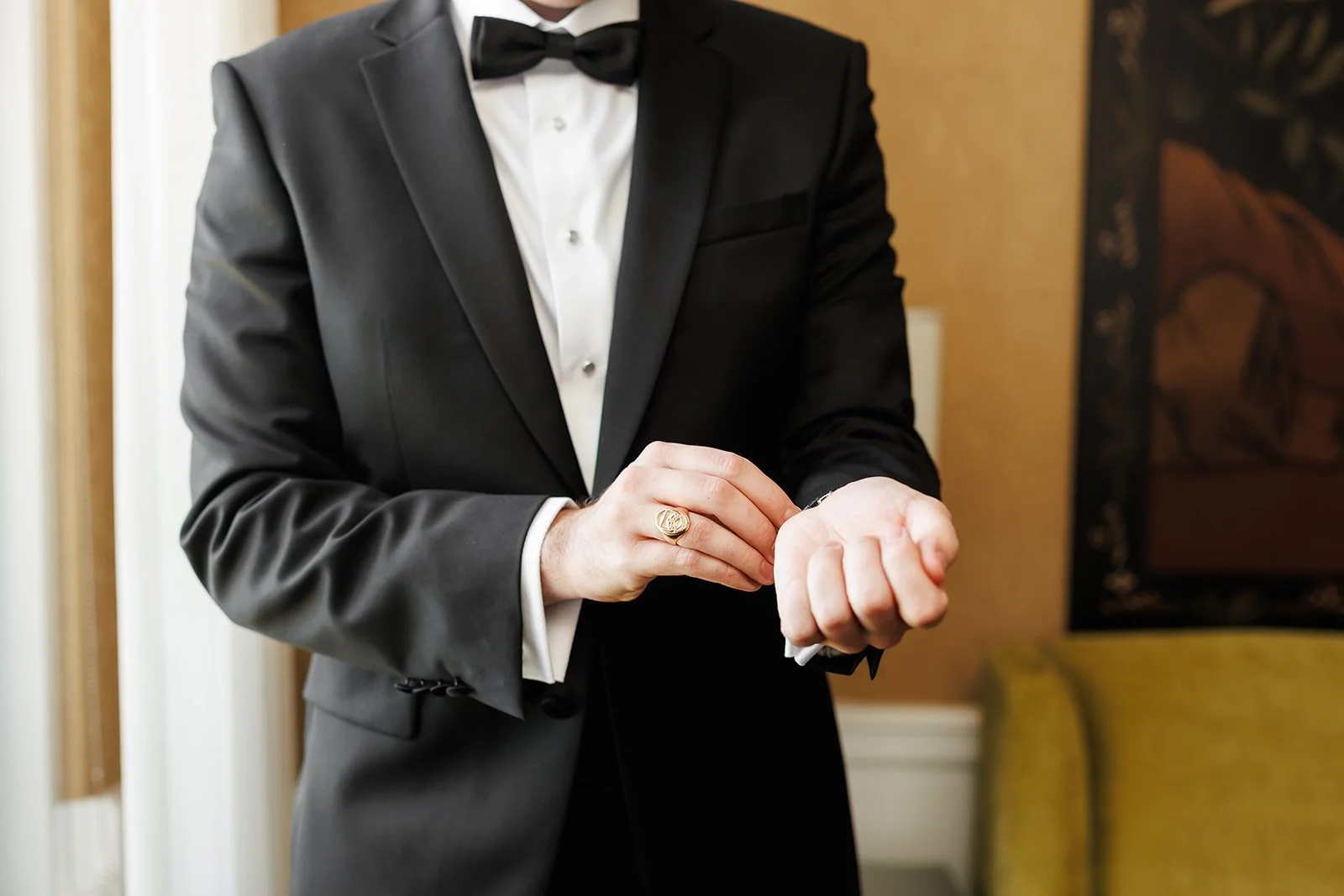 Groom fastening cufflinks in elegant hotel room – Houston wedding photography – Wild Ivy Creative Photography