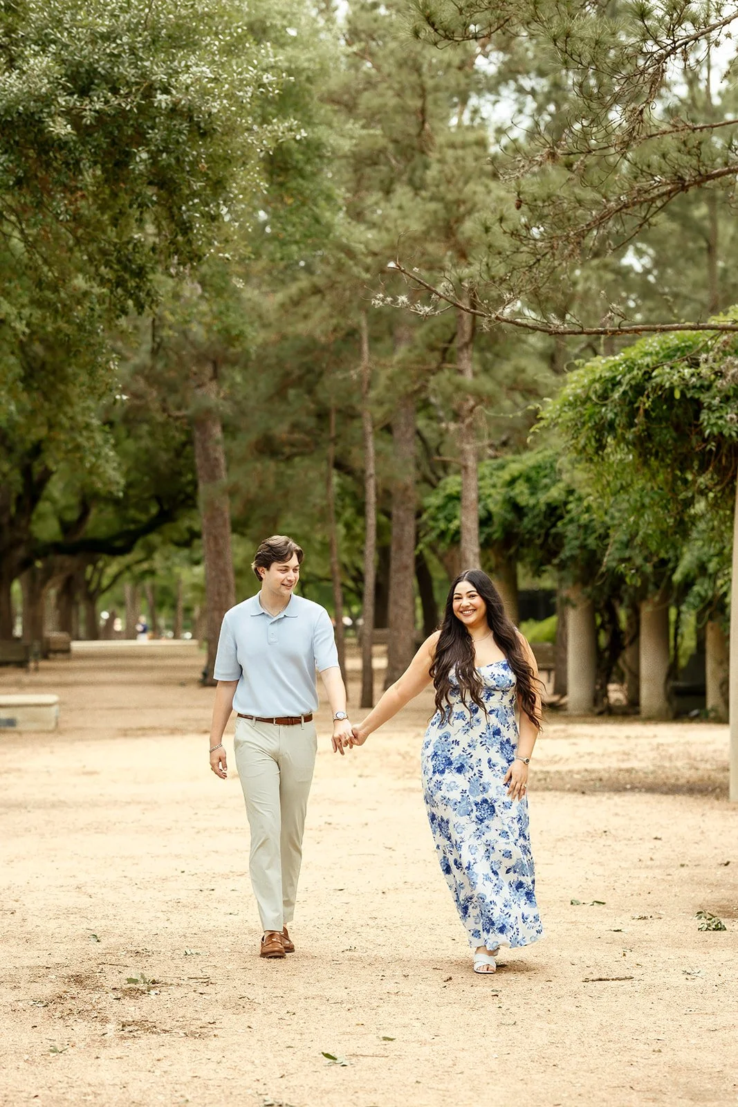 Candid moment of couple walking in the historic Hermann Park near Downtown Houston, Texas, photographed by top rated engagement and wedding photographer, Wild Ivy Creative