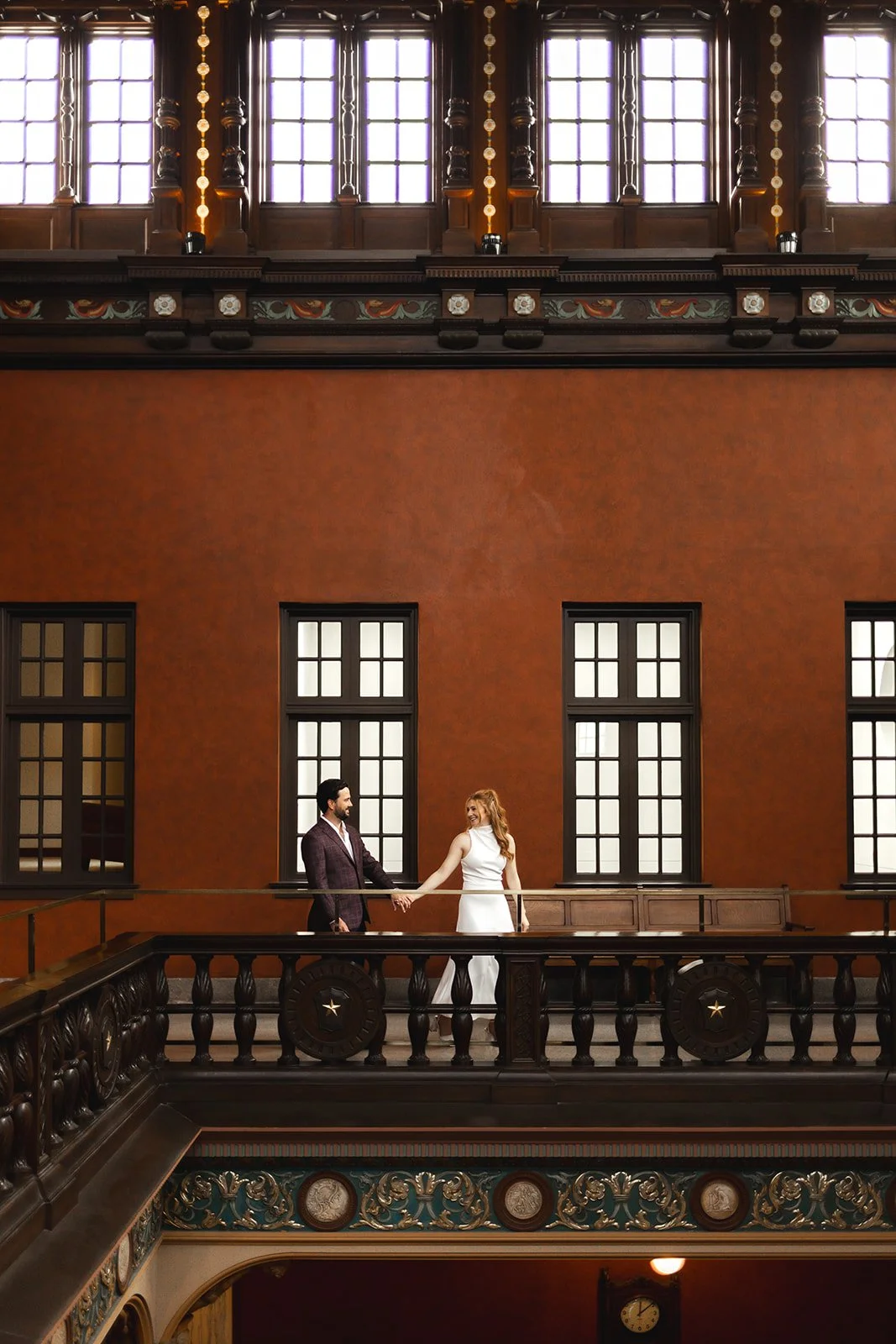 Elegant Downtown Houston engagement session photographed inside the historic Julia Ideson Building with romantic arches, classic architecture, and intimate storytelling moments captured by one of the best Houston engagement photographers.
