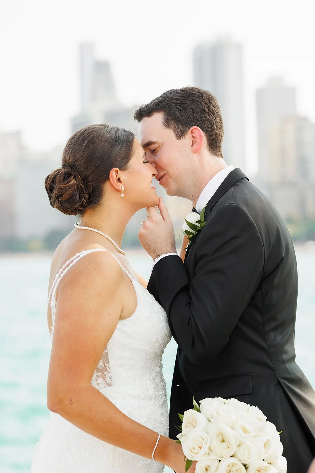 Intimate kiss between newlyweds with Houston skyline lights in the background – Houston wedding photographer – Wild Ivy Creative Photography