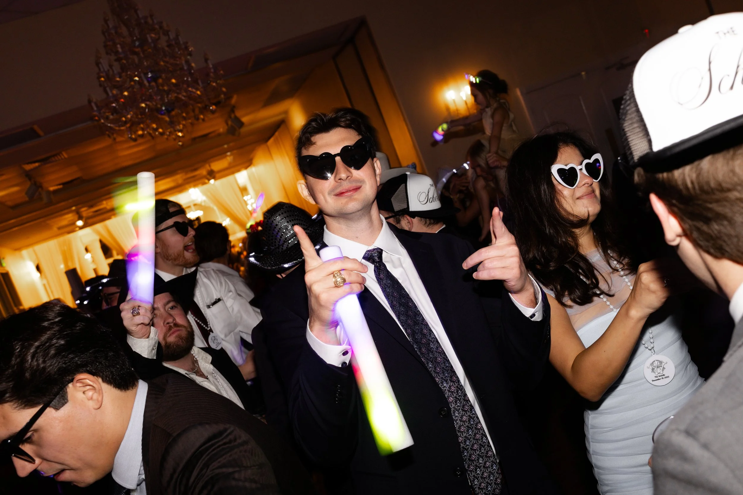 Friends dancing at an Ashton Gardens Wedding Venue in Houston, captured by Wild Ivy Creative Photography after an elegant wedding day