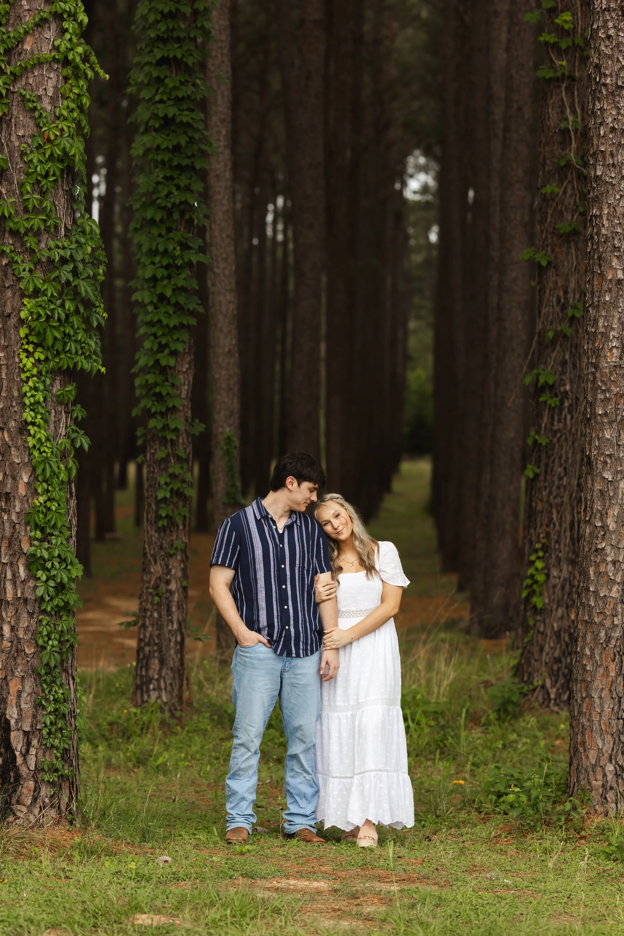 Couple having a candid moment during their engagement session at WG Jones state park with photographer Wild Ivy Creative based out of Houston and the Woodlands