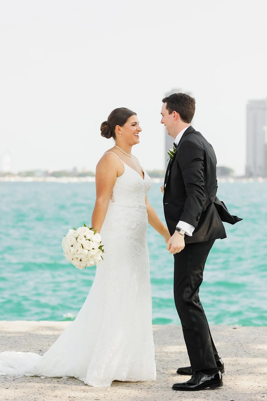 Bride and groom smiling and dancing with skyscrapers in view – Houston wedding photography – Wild Ivy Creative Photography