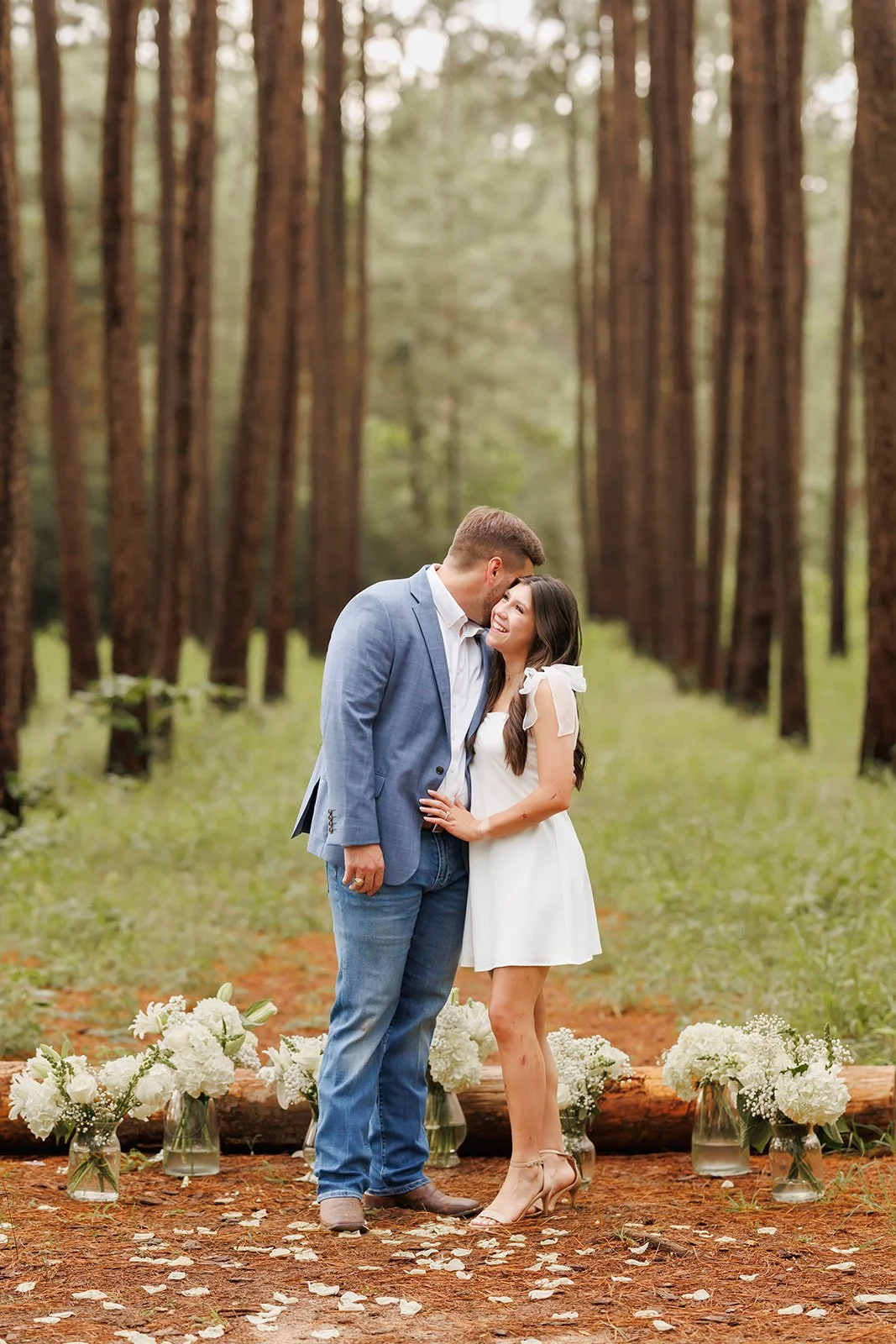 Candid wedding photography in a forest setting with floral decor and joyful couple moments, captured by Wild Ivy Creative.