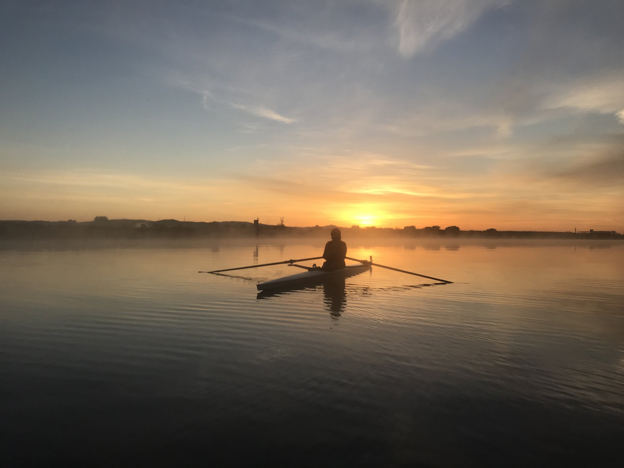 A member of the North Bay Rowing Club sculls at dawn on the Petaluma River. (2019)