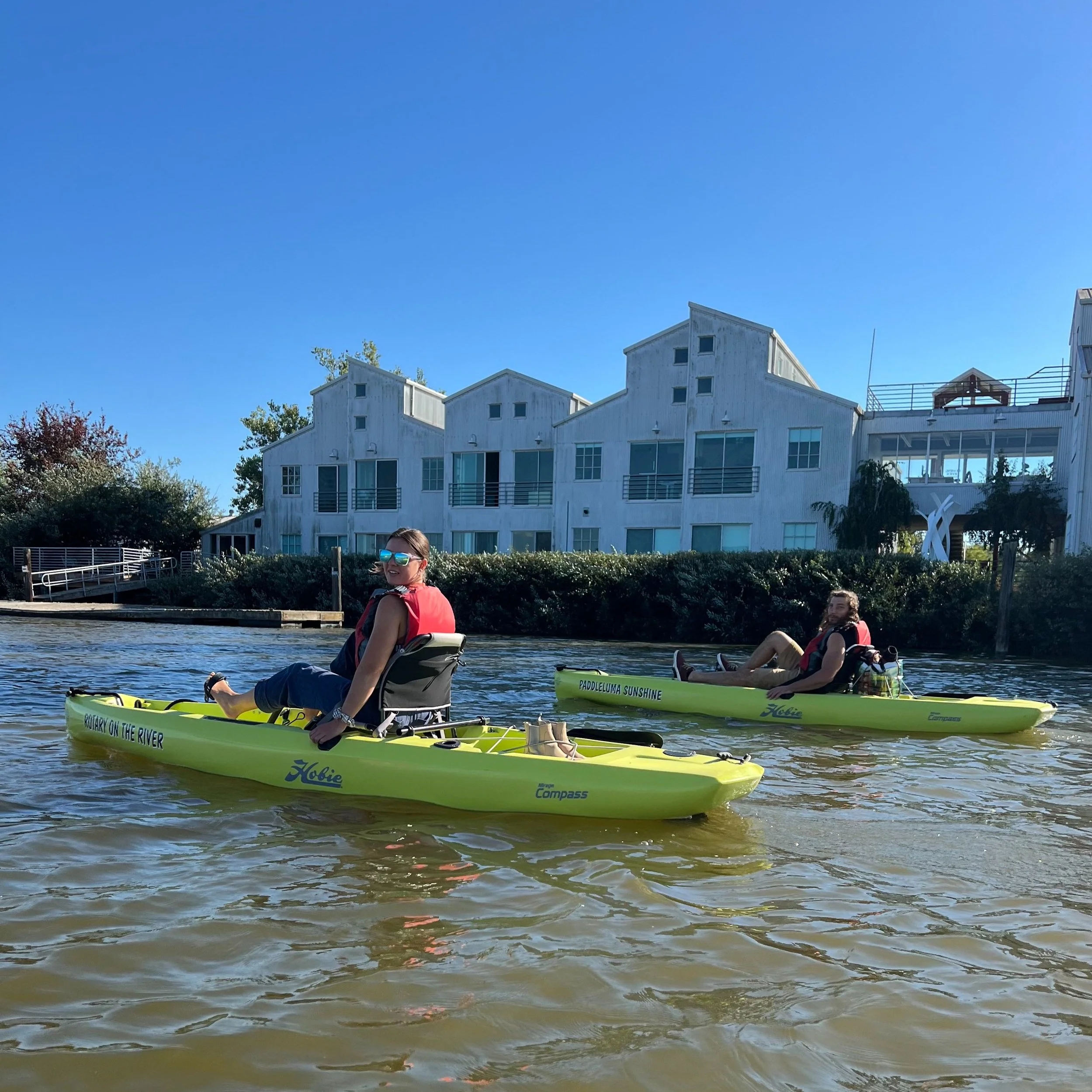 Floathouse Petaluma guest pedal Hobie kayaks past Foundry Wharf, a mixed-use development created by real estate developer Walter Haake in 1987 on a site formerly occupied by the Kresky Manufacturing Company. 