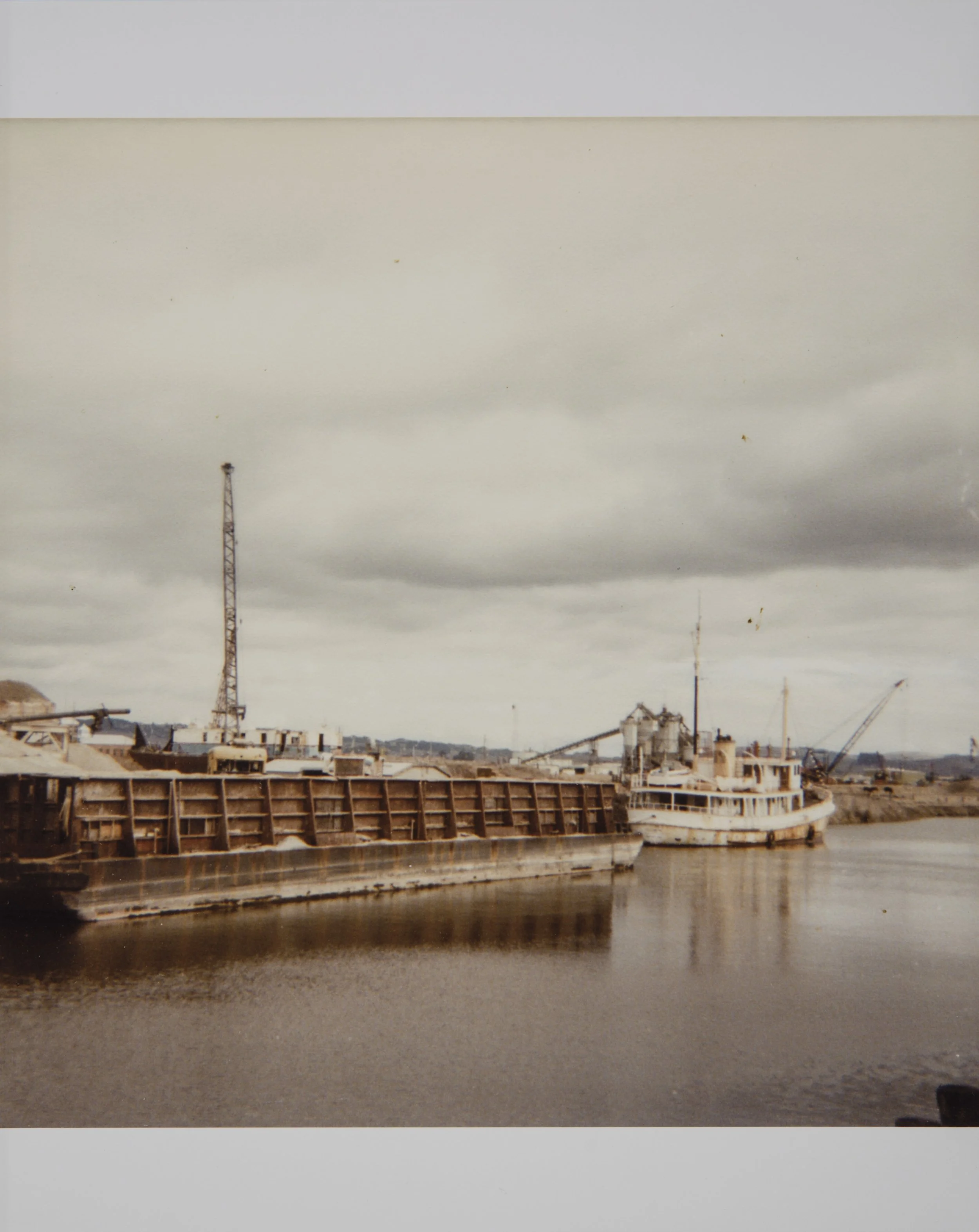 Sand barge and steamer moored on Petaluma River. October, 1981