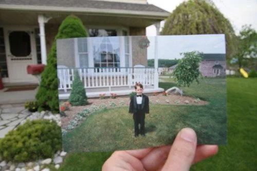 childhood photo held in front of childhood home to depict looking back at childhood in therapy