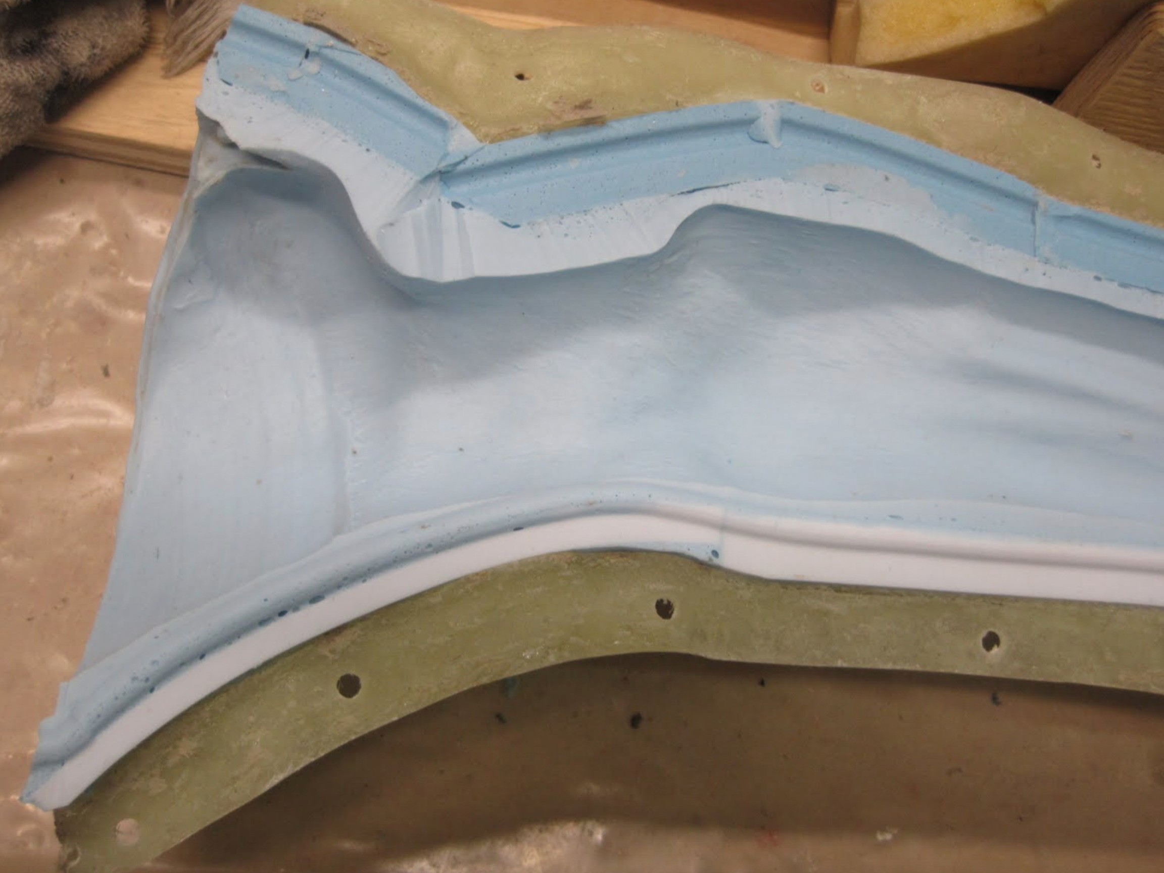  This photo shows the interior of the finished mold, along with the fiberglass jacket. 