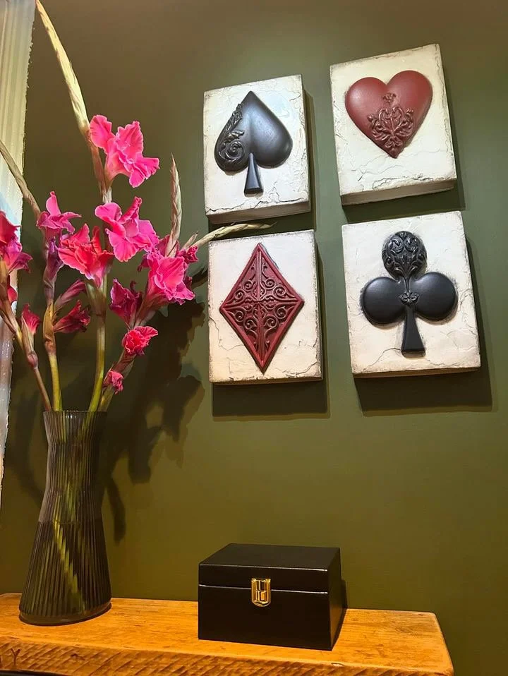 A Sid Dickens Memory Block on display with a vase of pink flowers