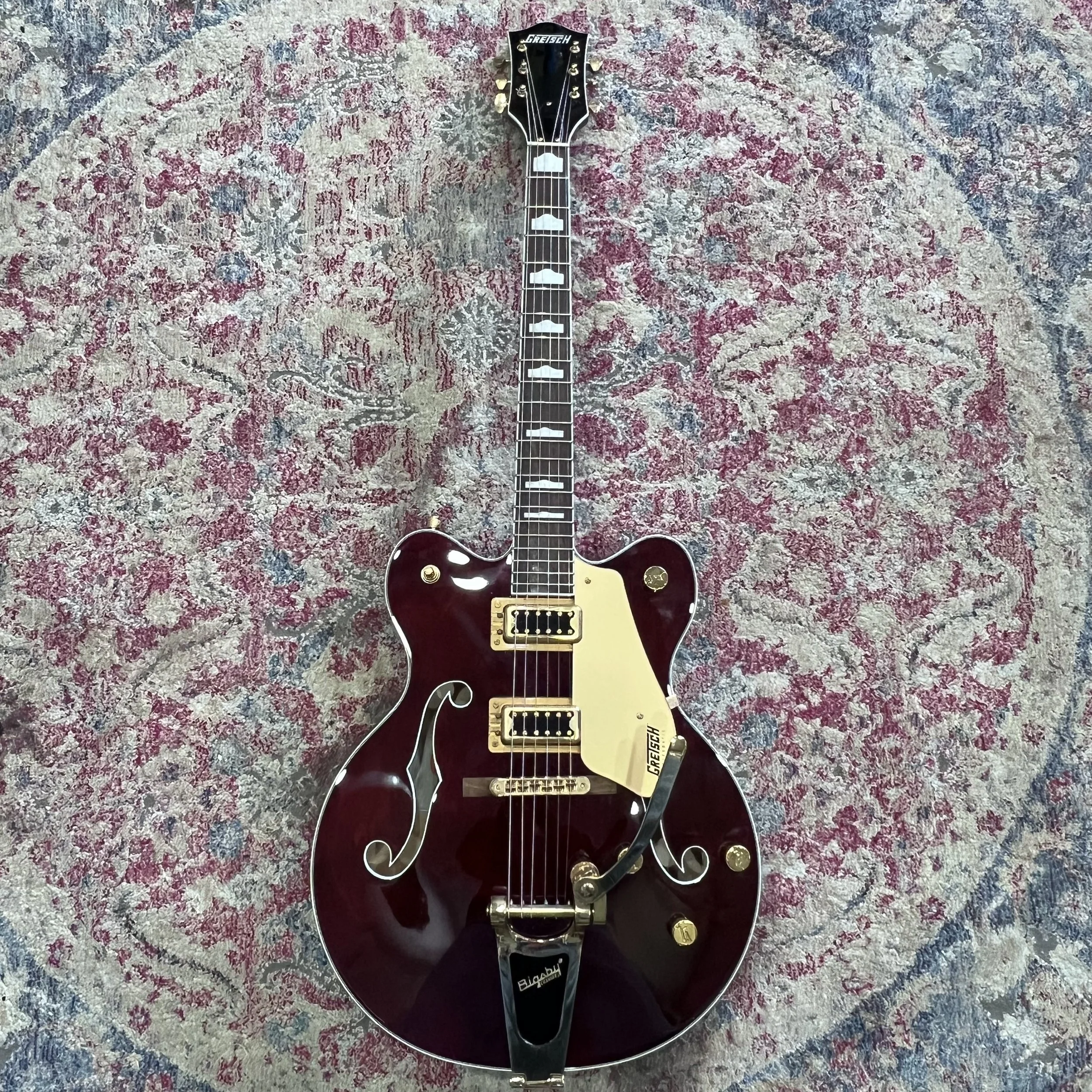 Gretsch Electromatic hollow-body guitar in Walnut Stain with gold hardware, Bigsby vibrato, and gold pickguard.jpeg