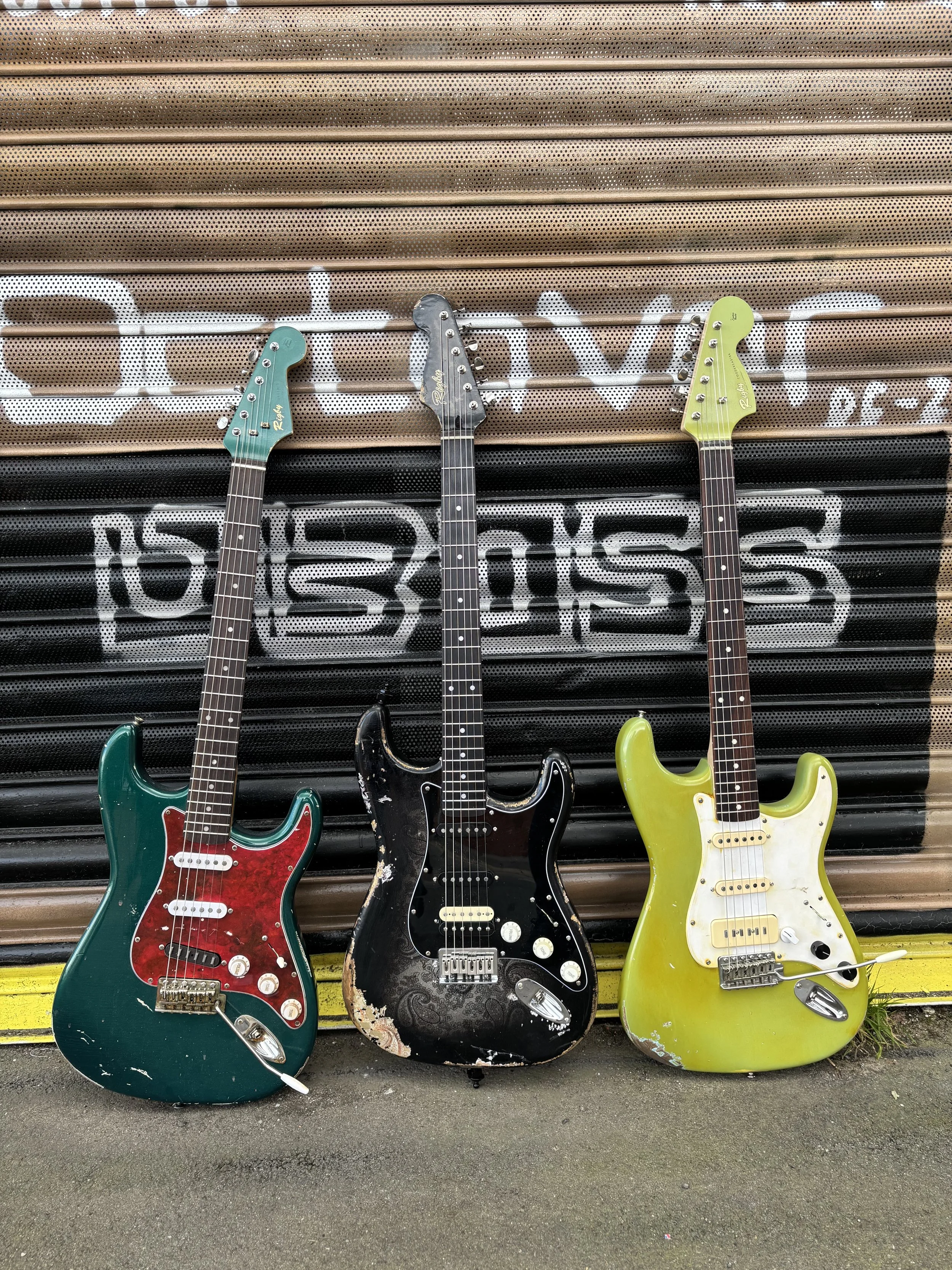 three strats custom built, light green, dark green and black with matching headstocks