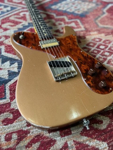 creme, brown Telecaster with bridge humbucker and tortiseshell pickguard.
