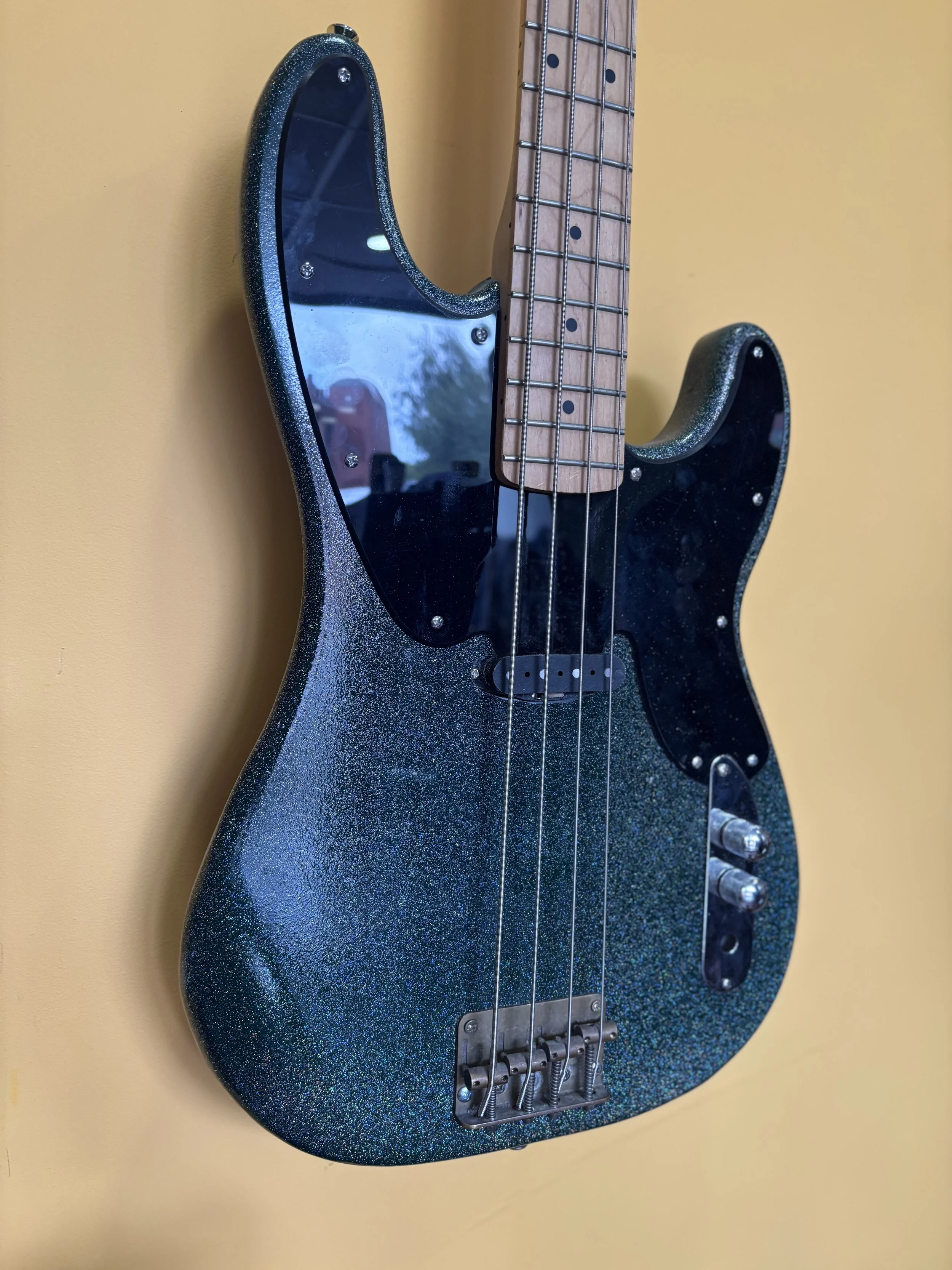 modern sparkle dark green p bass , black pickguard and silver chrome knobs, maple neck.