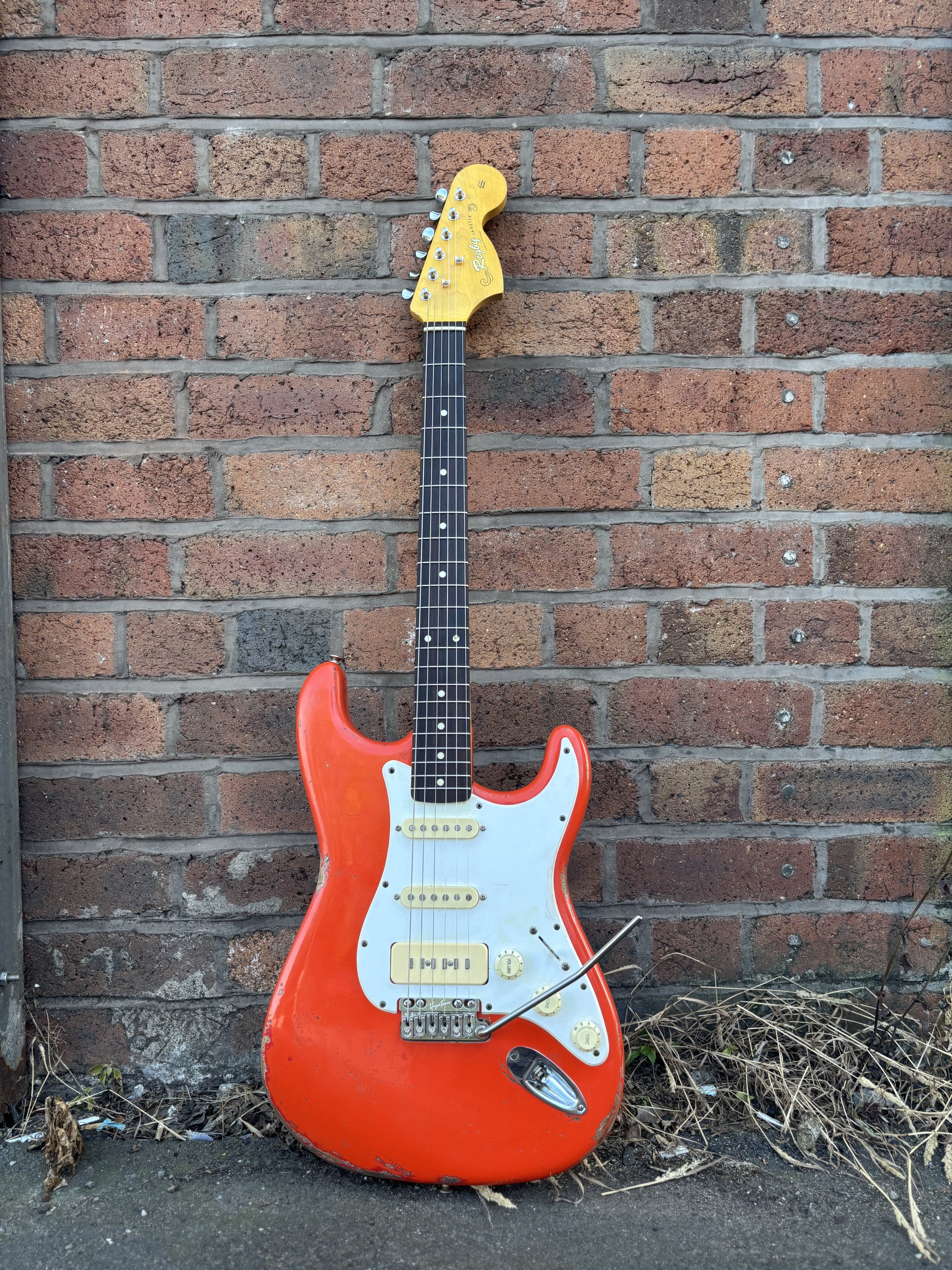 fiesta red HSS stratocaster, white pickguard, rosewood neck, yellowed green pickups.