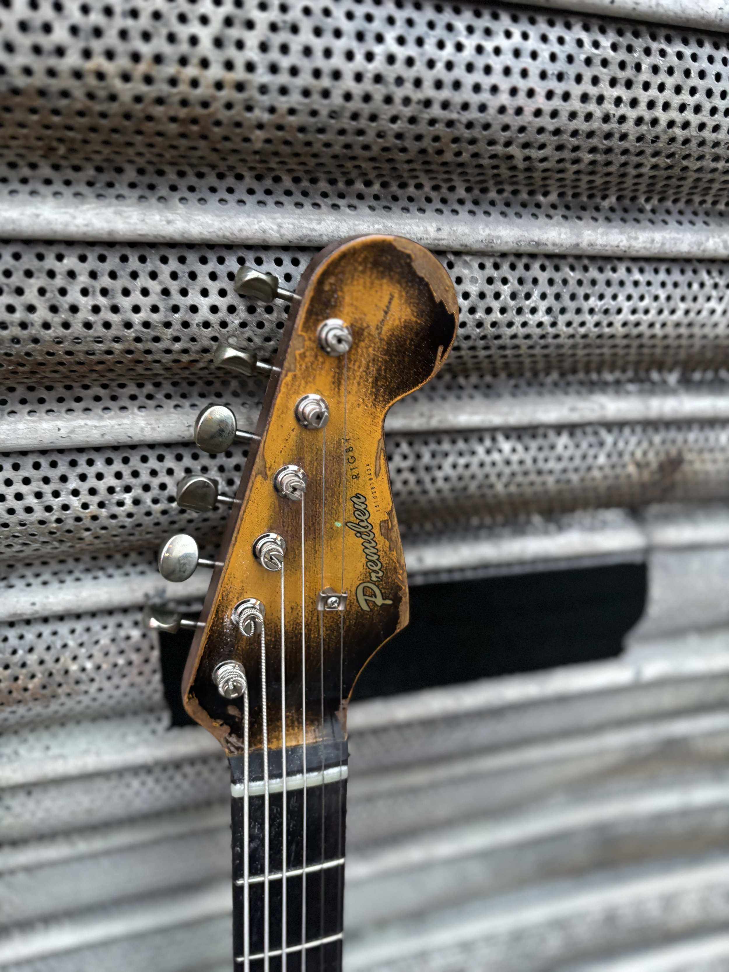 baritone, gold pick guard 2 x P90 orange and brown reliced body and rosewood neck matching headstock