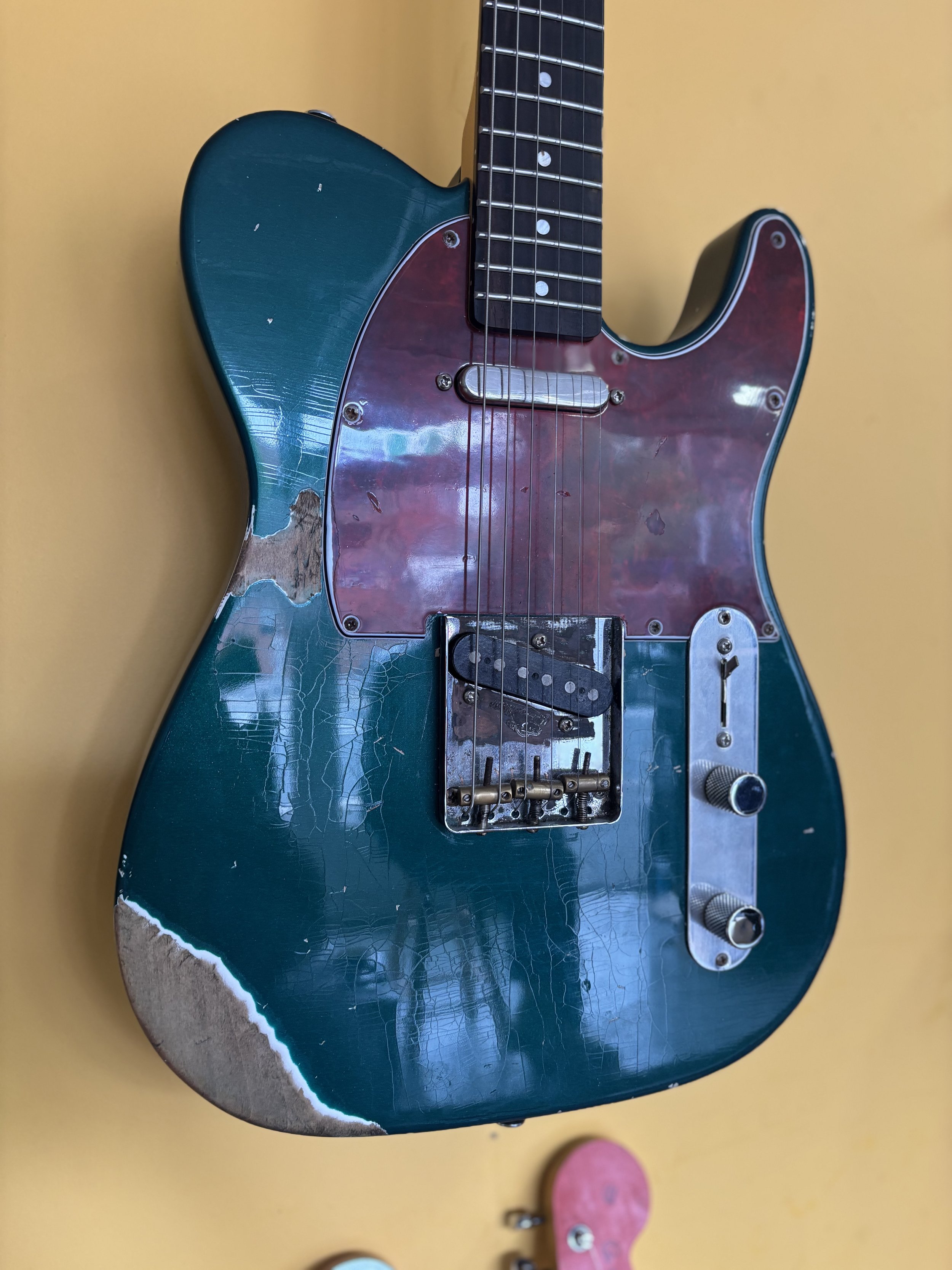 classic reliced telecaster, dark green, red tortiseshell pickguard, rosewood neck, brass saddles.