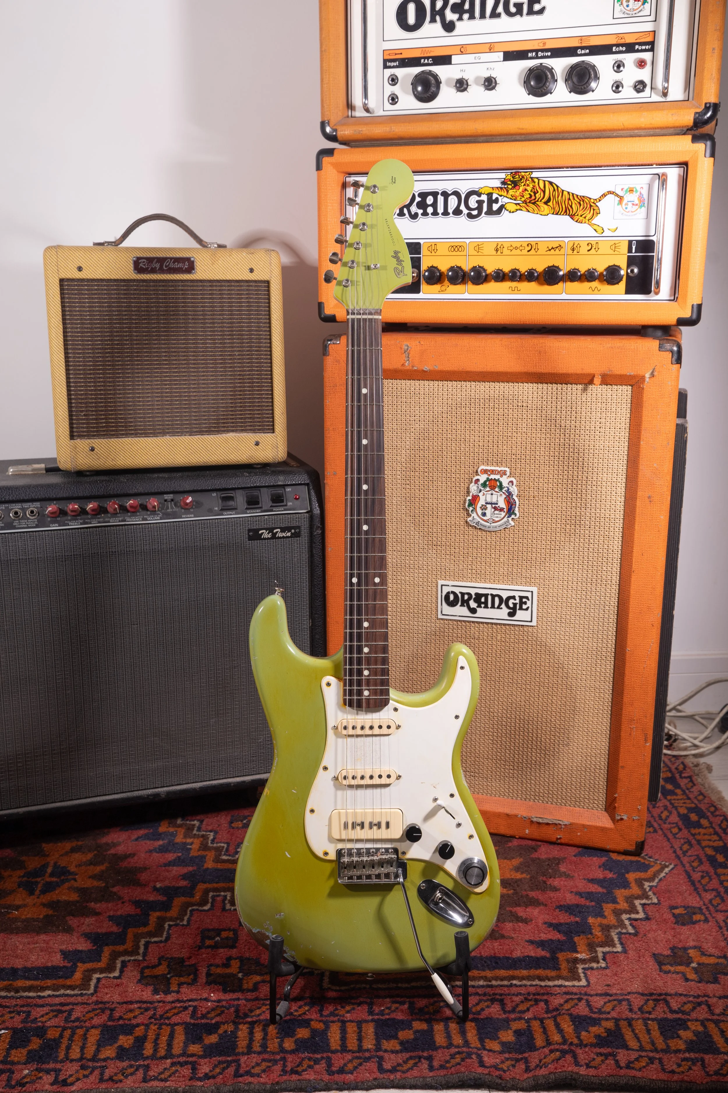 Green HSS Stratocaster with white pickguard reliced with black control knobs, trem arm and yellowed greens pickups